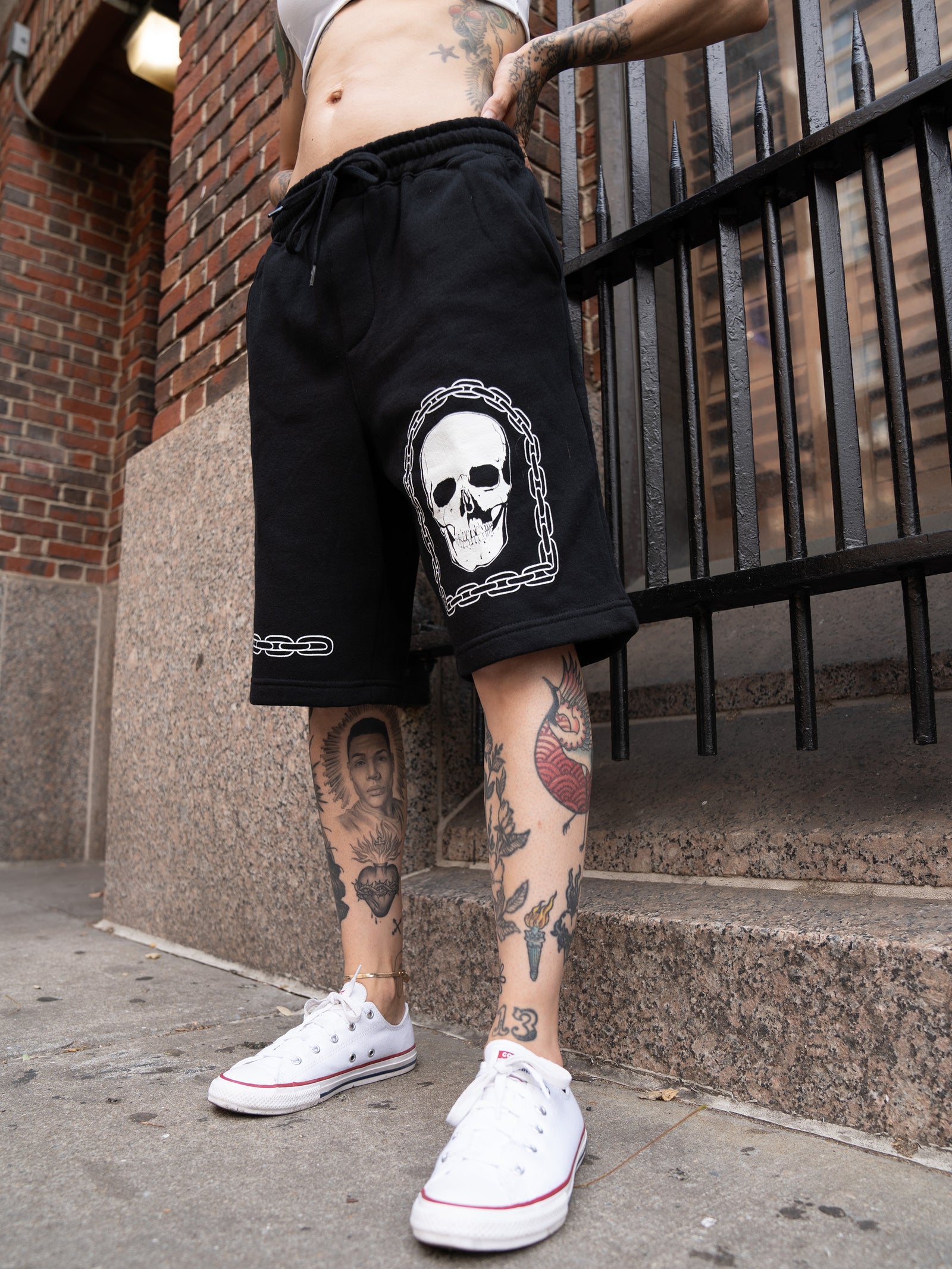 Black, cotton unisex sweat shorts with white chain and skull graphics