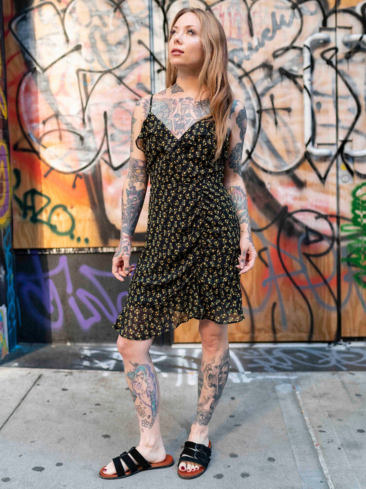 Megan Massacre in the floral patterned Daydreamer Dress with black boots.