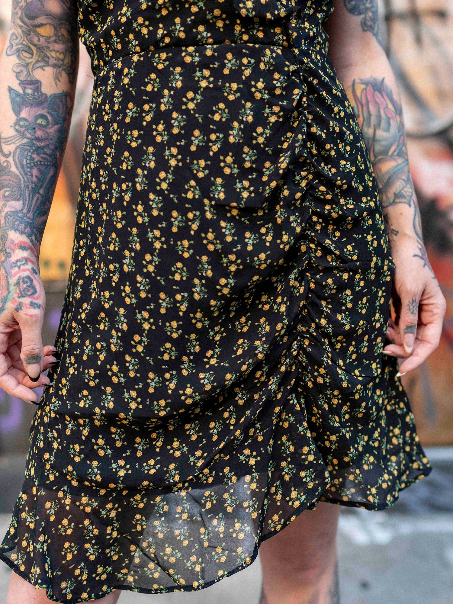 Megan Massacre in the floral patterned Daydreamer Dress with black boots.