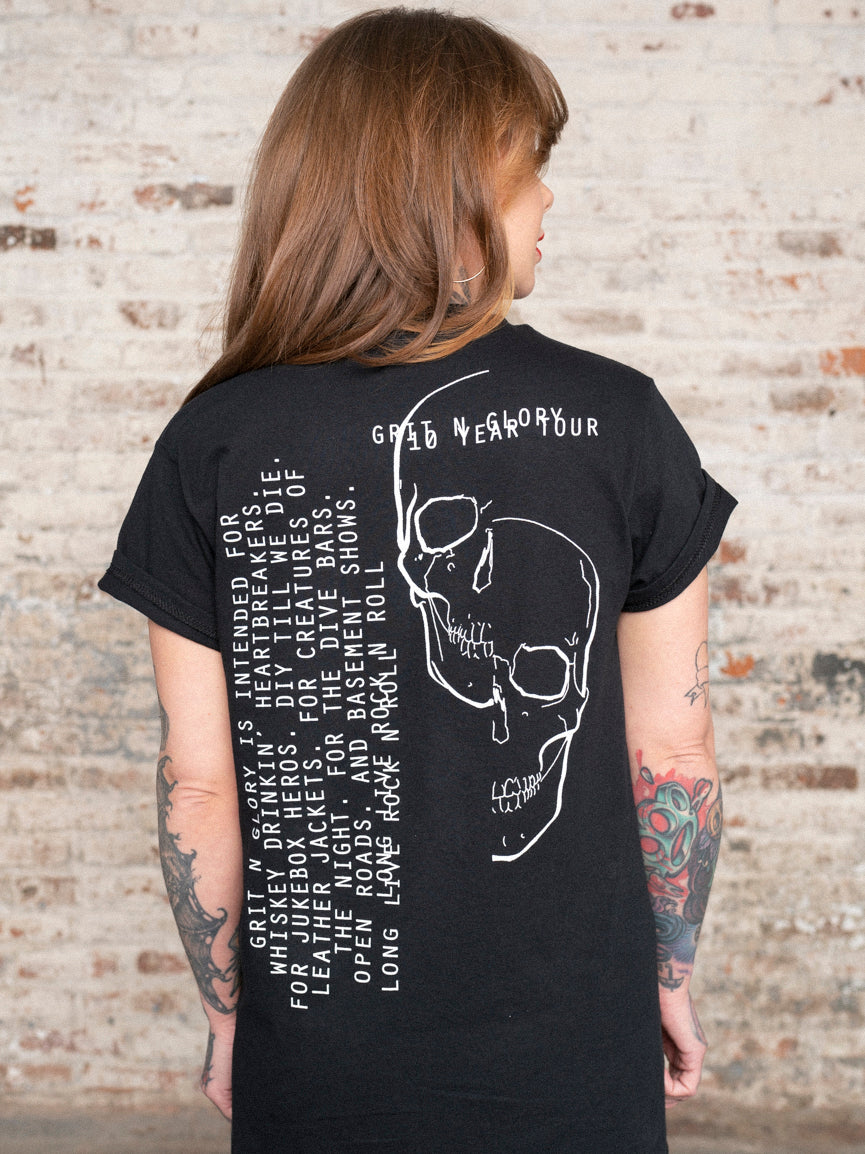 Back of the 10 year Tour tee with split skull design in white.