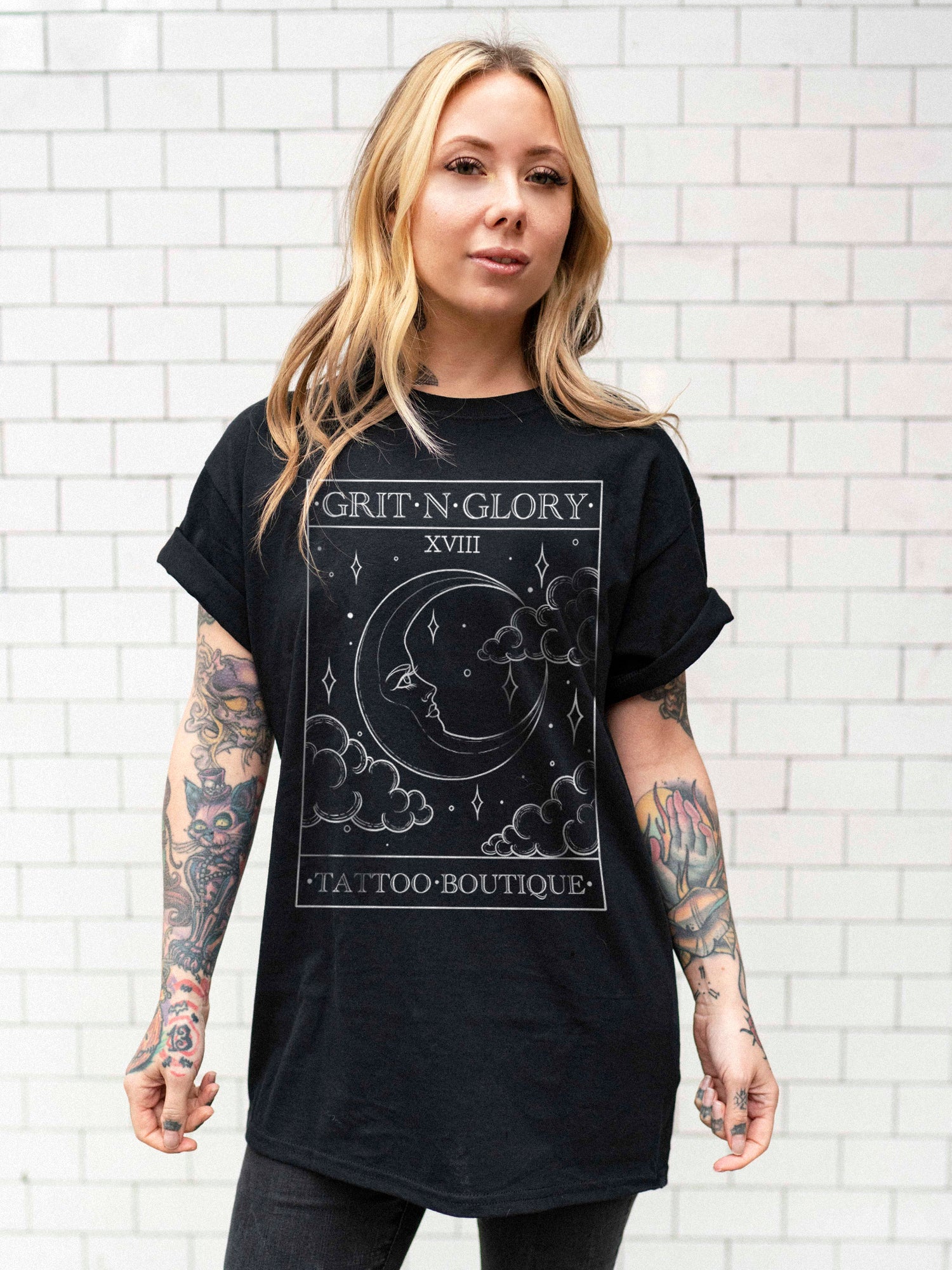 Megan Massacre wearing a black unisex t-shirt with an ornate tarot card moon design by Grit N Glory tattoo artist Charlotte Timmons.
