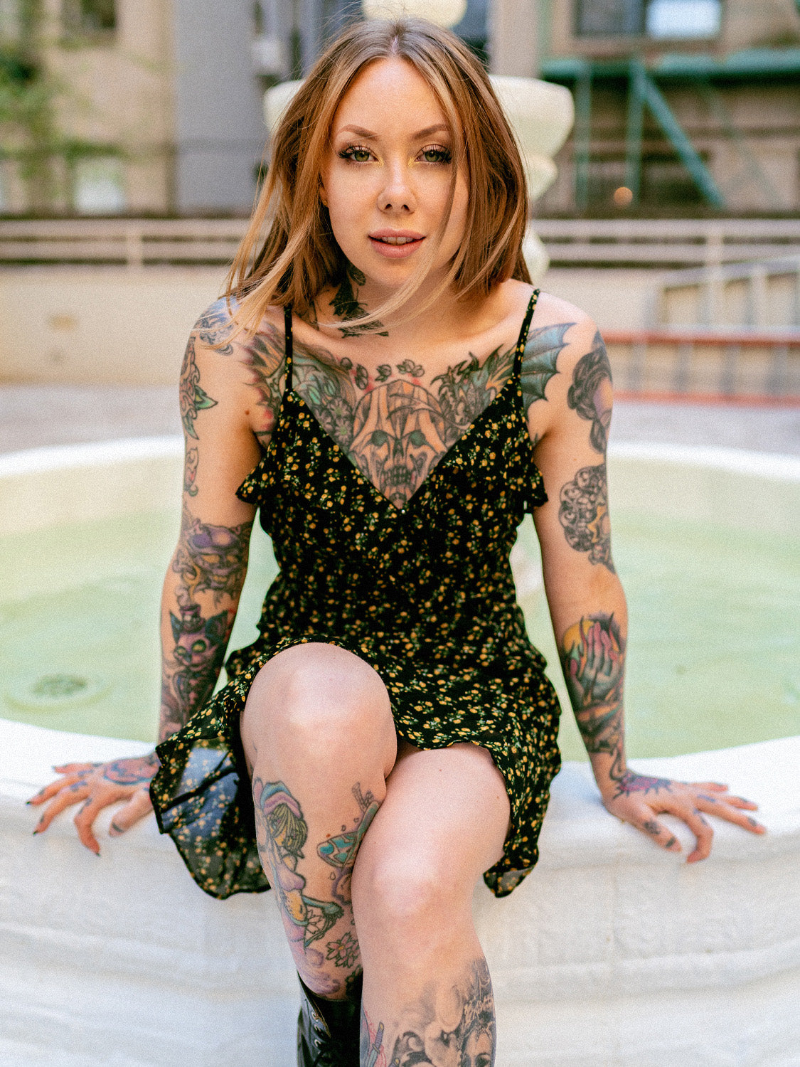 Megan Massacre in the floral patterned Daydreamer Dress with black boots.