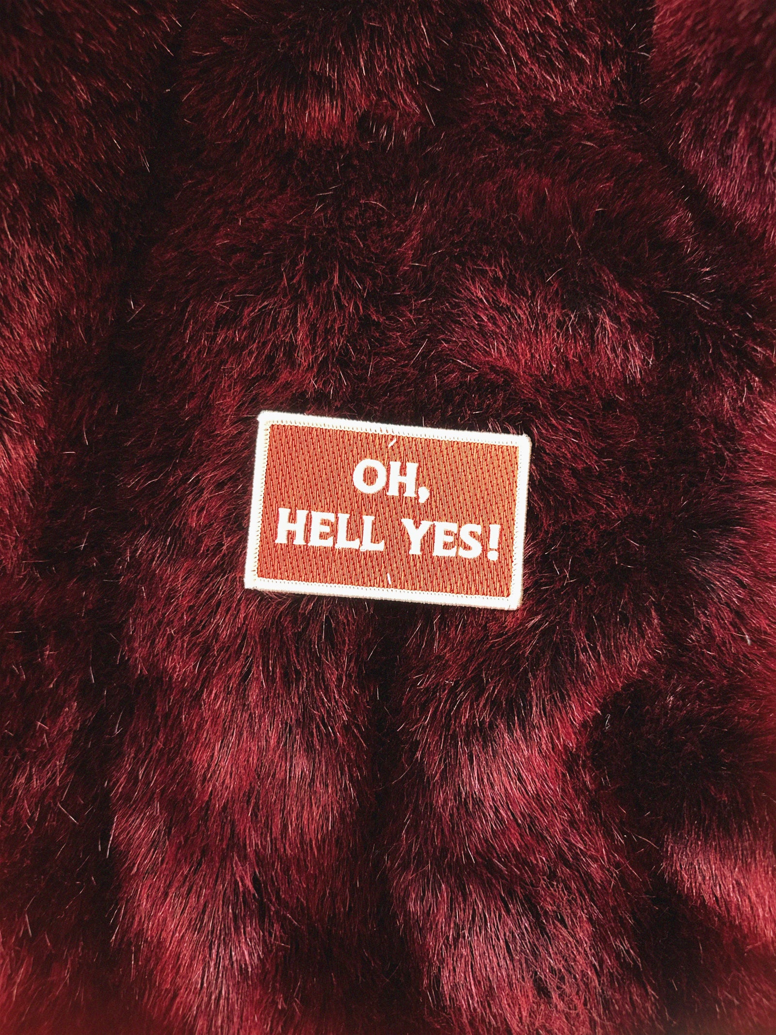 Patch with 'Oh, Hell Yes!' text on a red fabric background