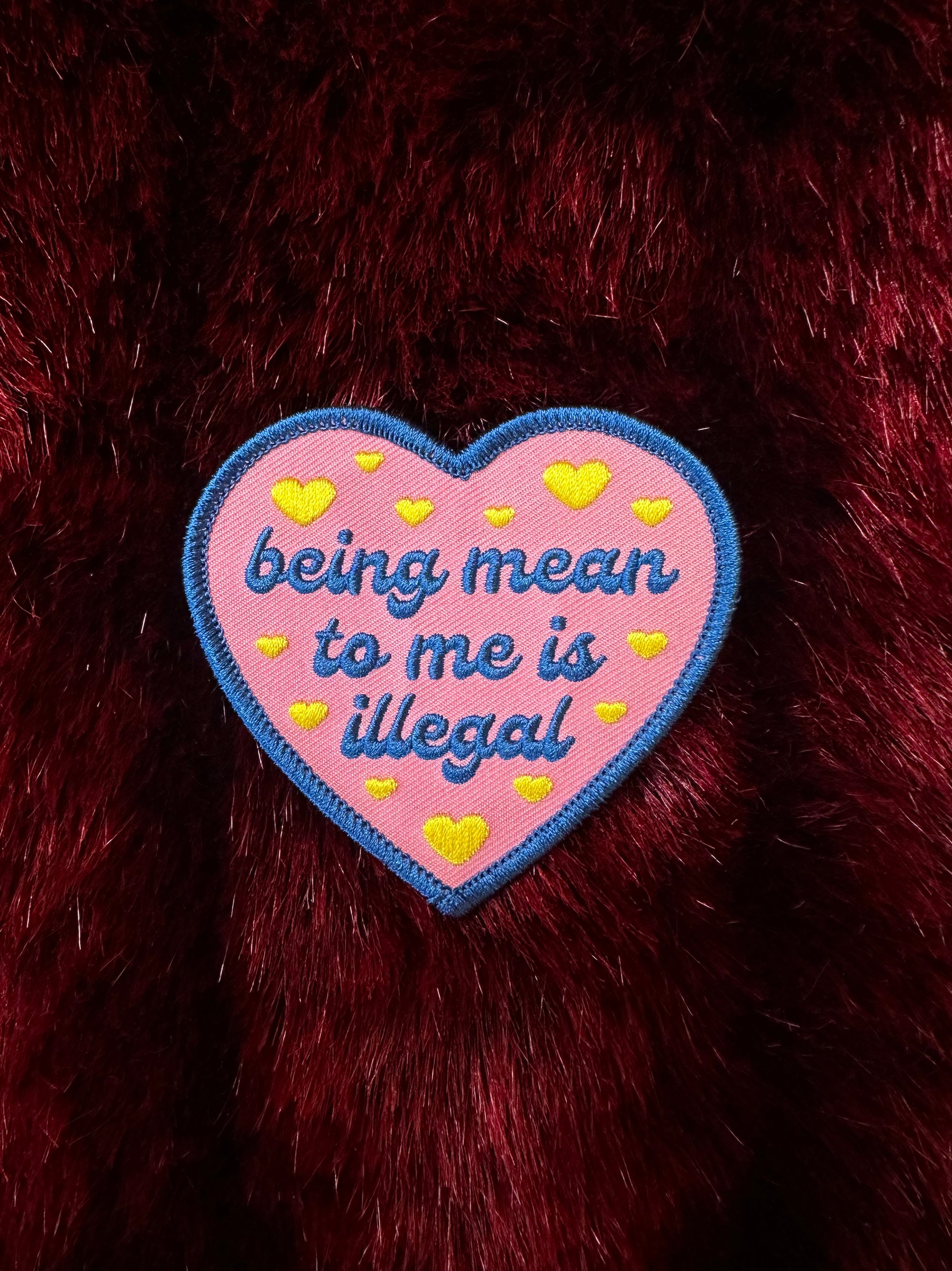 Heart-shaped patch with text on a fur background