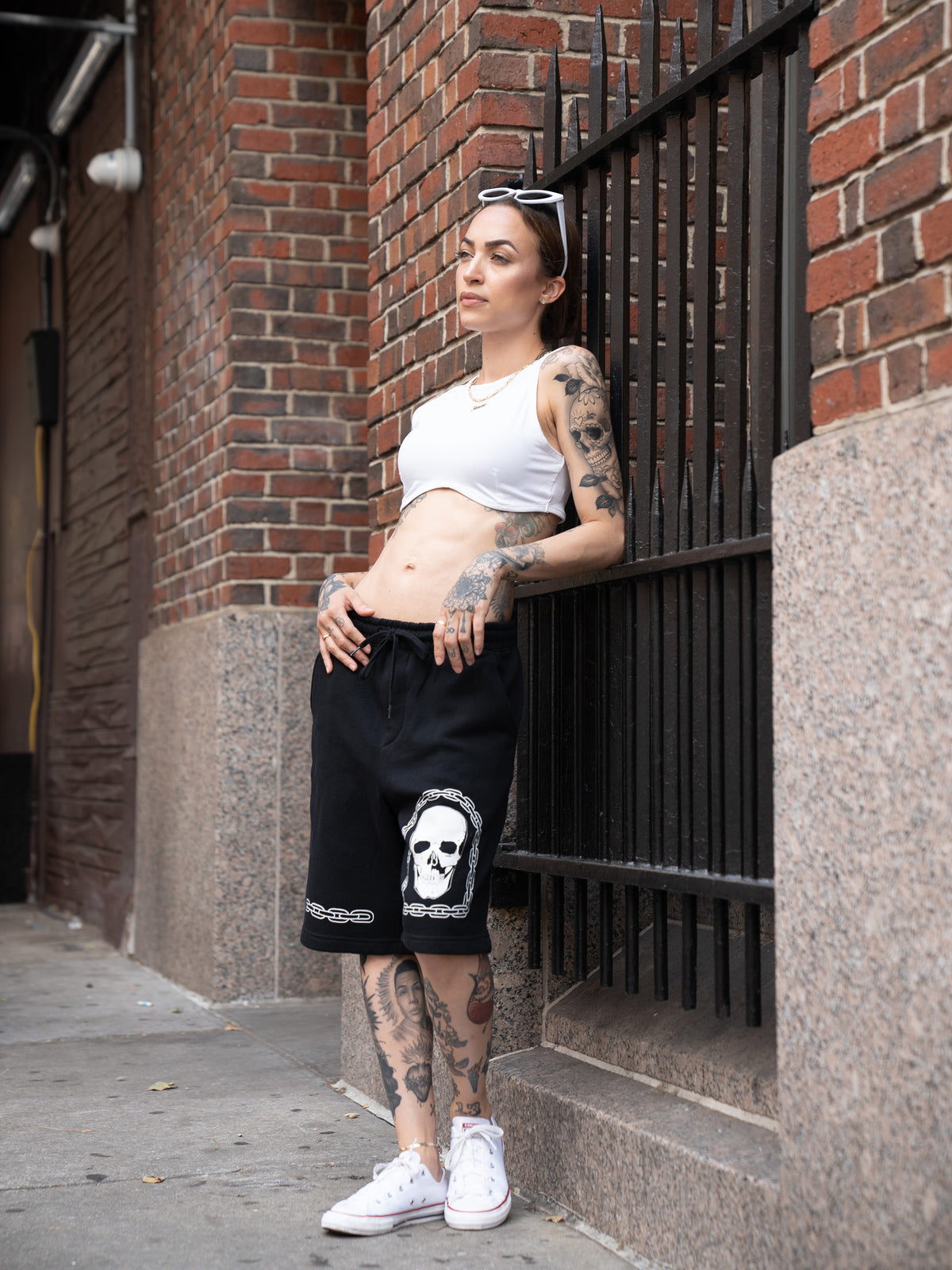 Janice Danger wearing Chain Skull black sweat shorts and white Love Song crop top