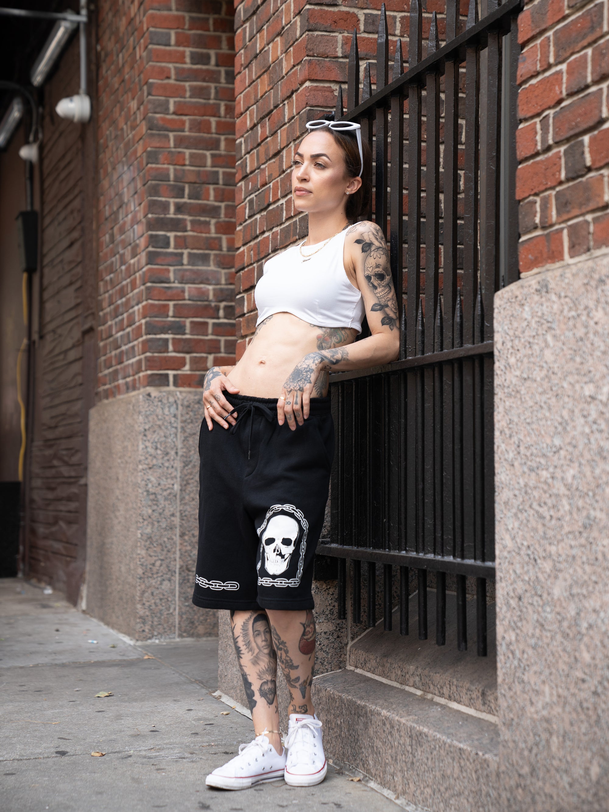Black, cotton unisex sweat shorts with white chain and skull graphics