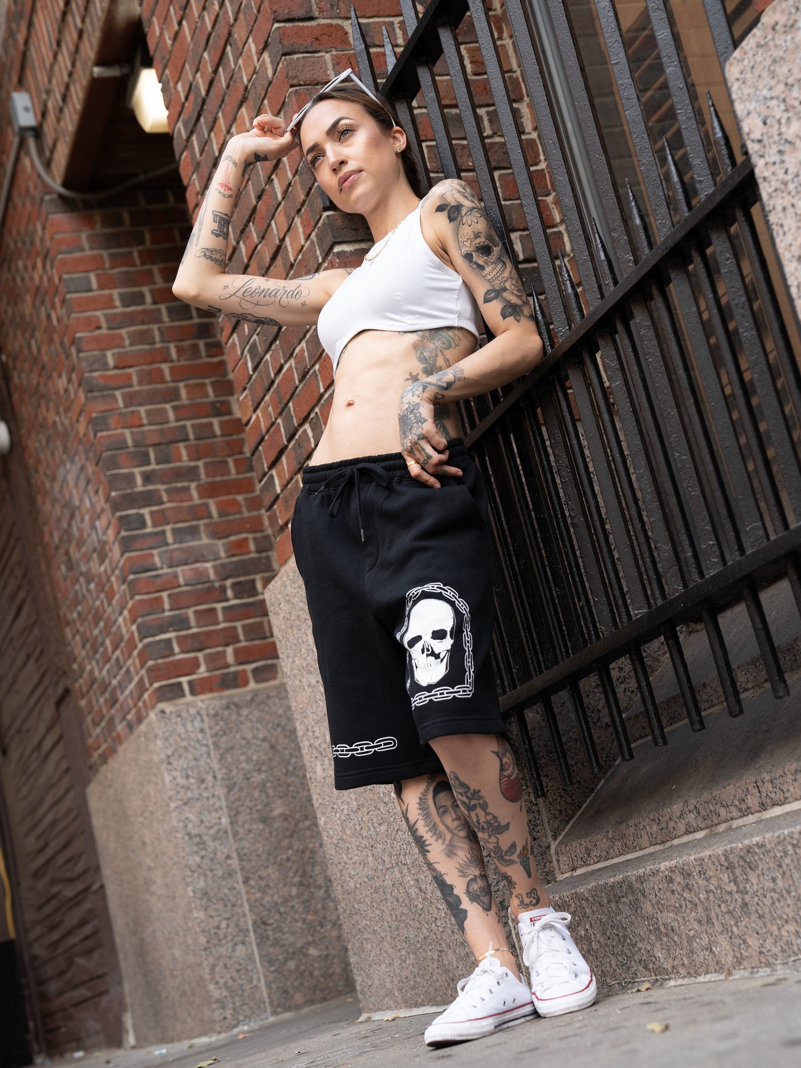 Janice Danger wearing Chain Skull black sweat shorts and white Love Song crop top