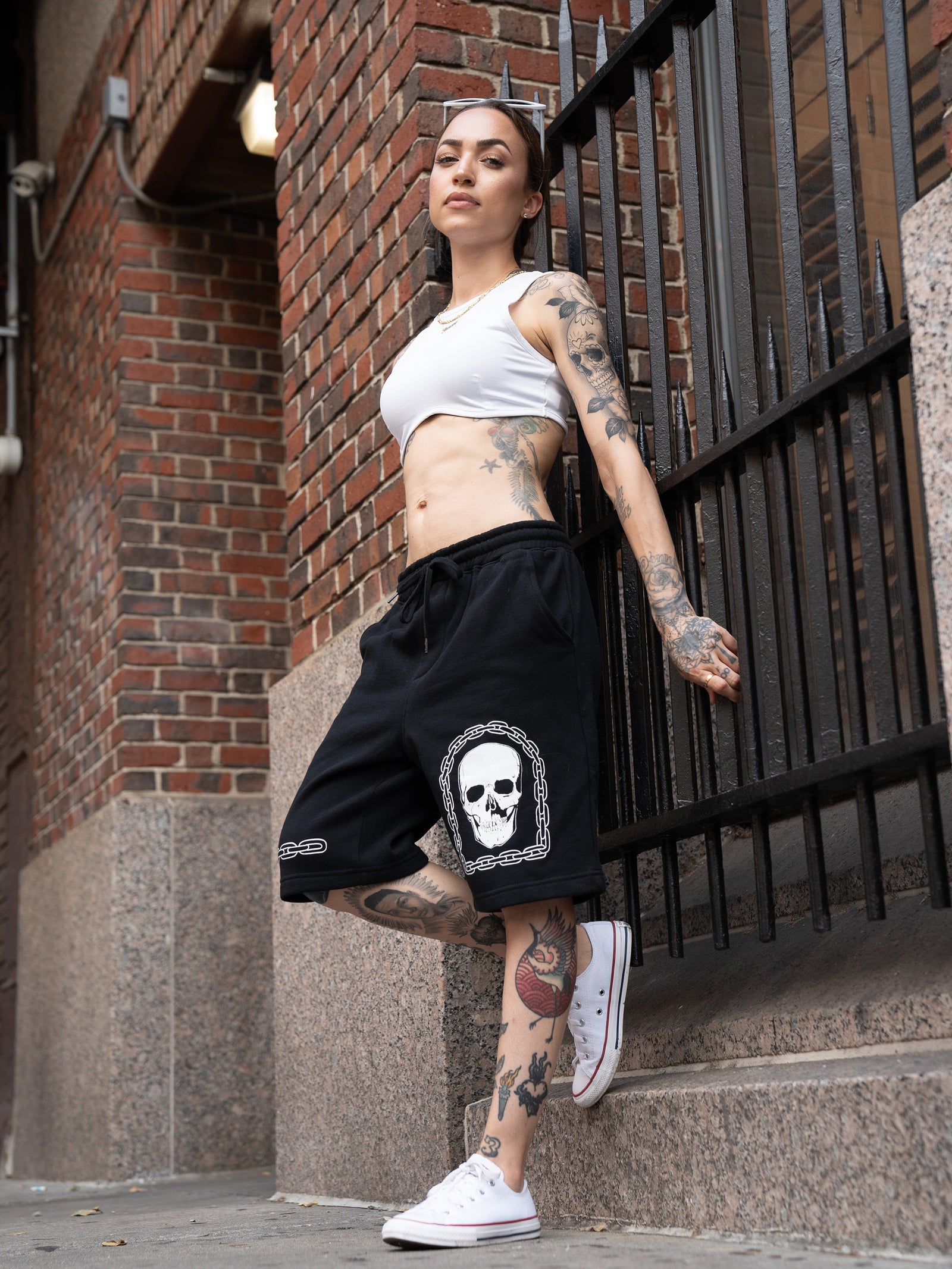 Janice Danger wearing the unisex, black Grit N Glory sweatshorts with the Love Song white crop top in Greenwhich Village NYC.