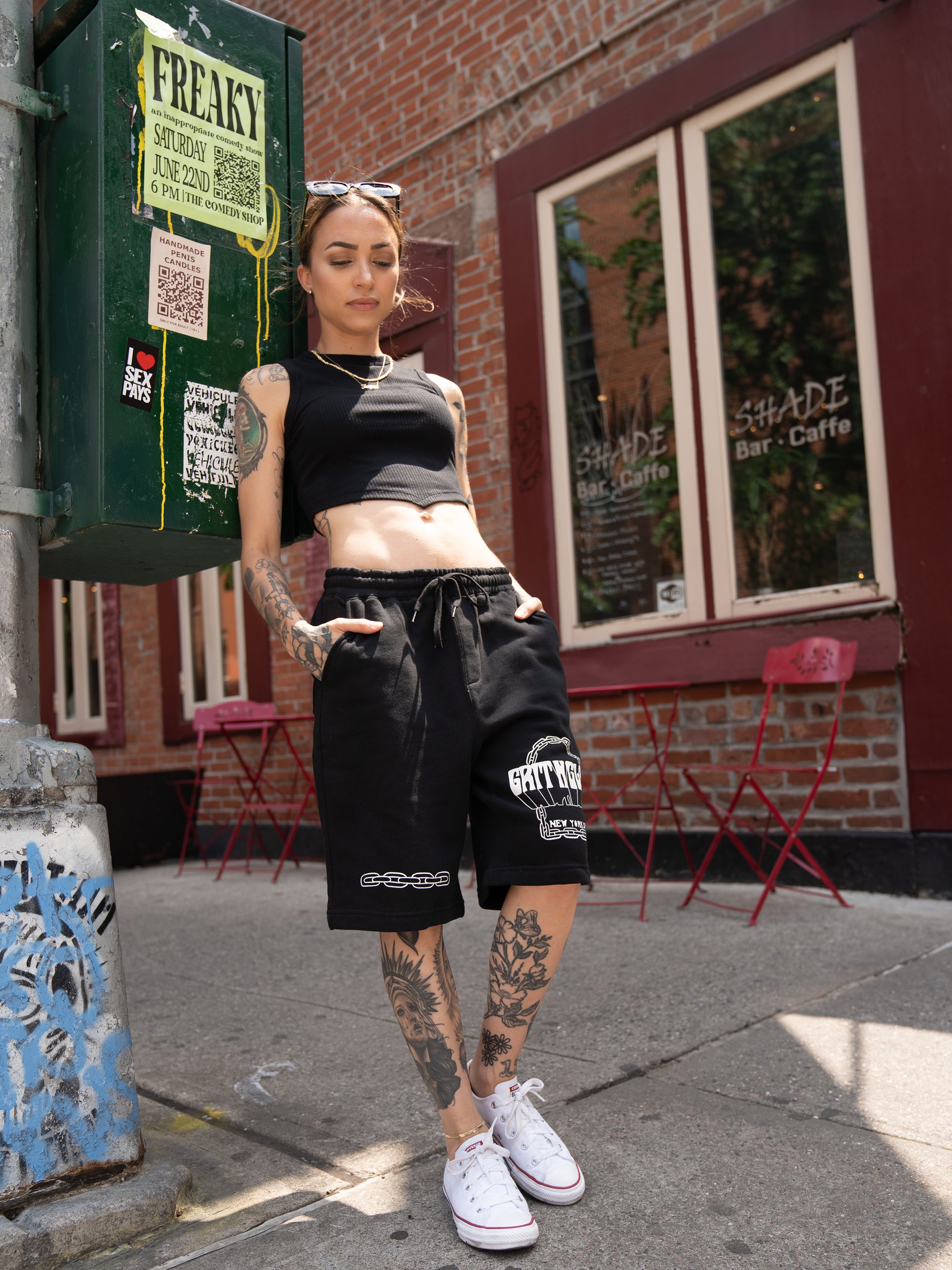 close up of black, unisex sweat shorts featuring chain graphics. 