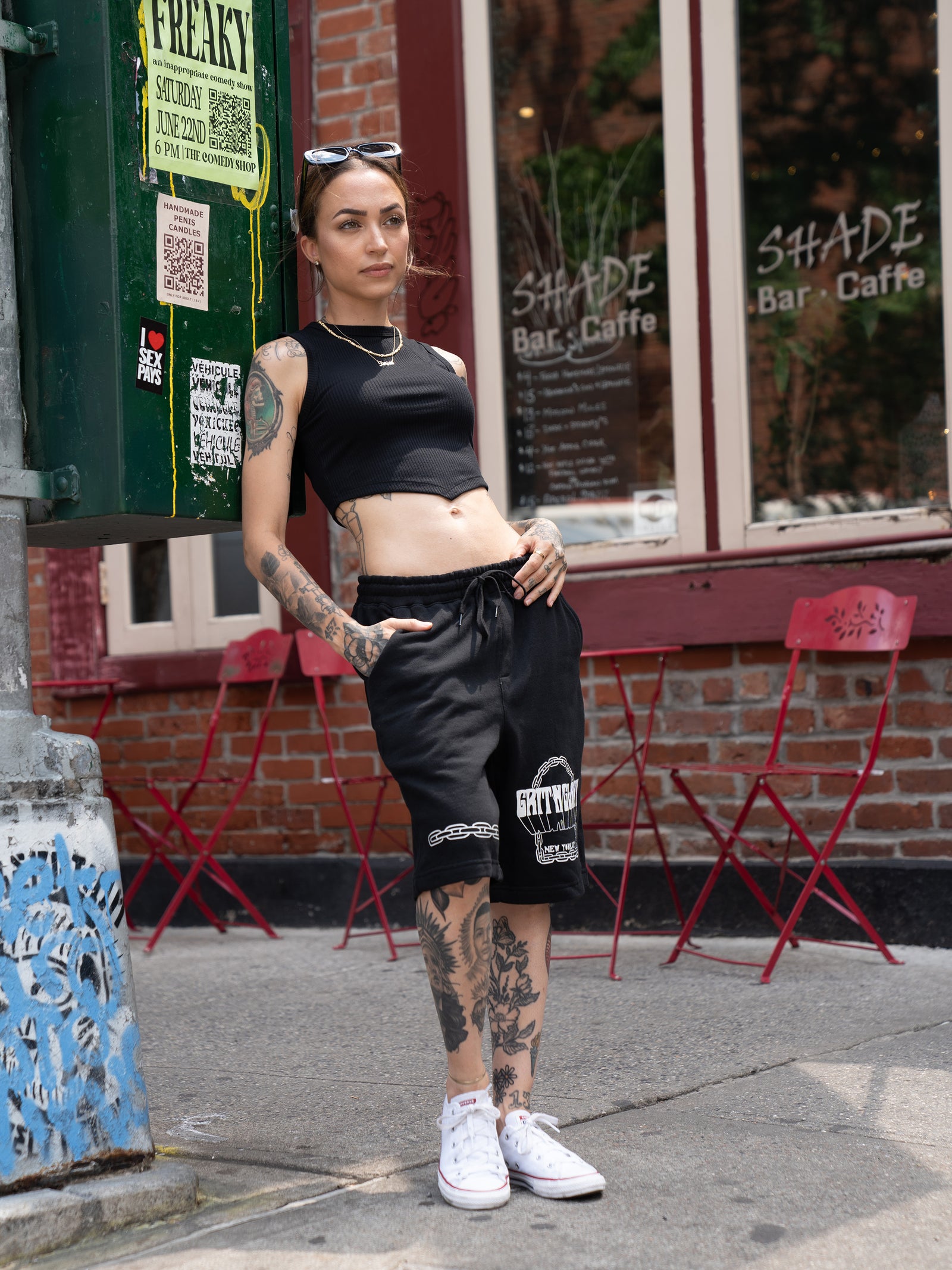 Janice Danger wearing the unisex, black Grit N Glory sweatshorts with the Love Song black crop top in Greenwhich Village NYC.