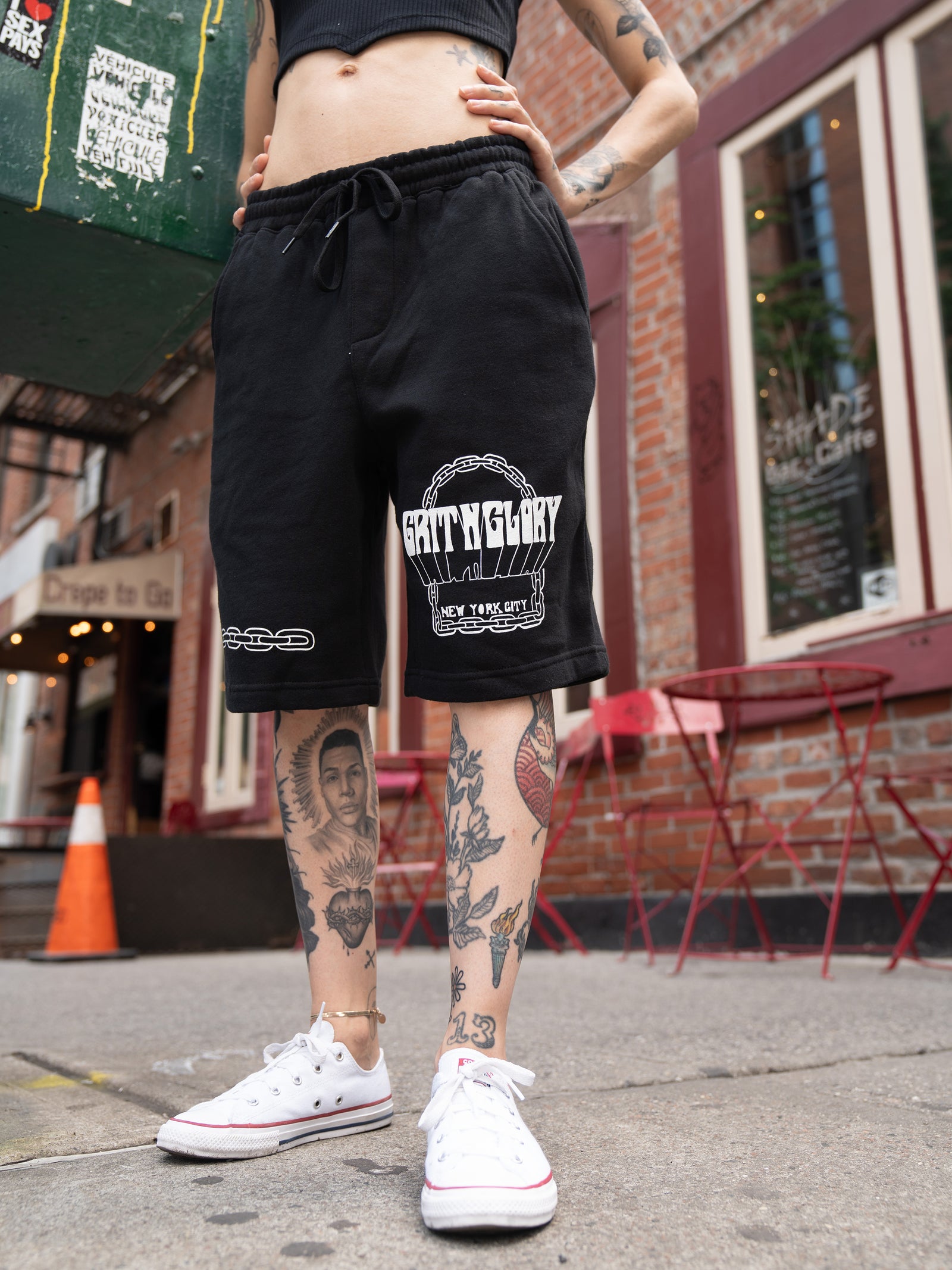 close up of black, unisex sweat shorts featuring chain graphics. 