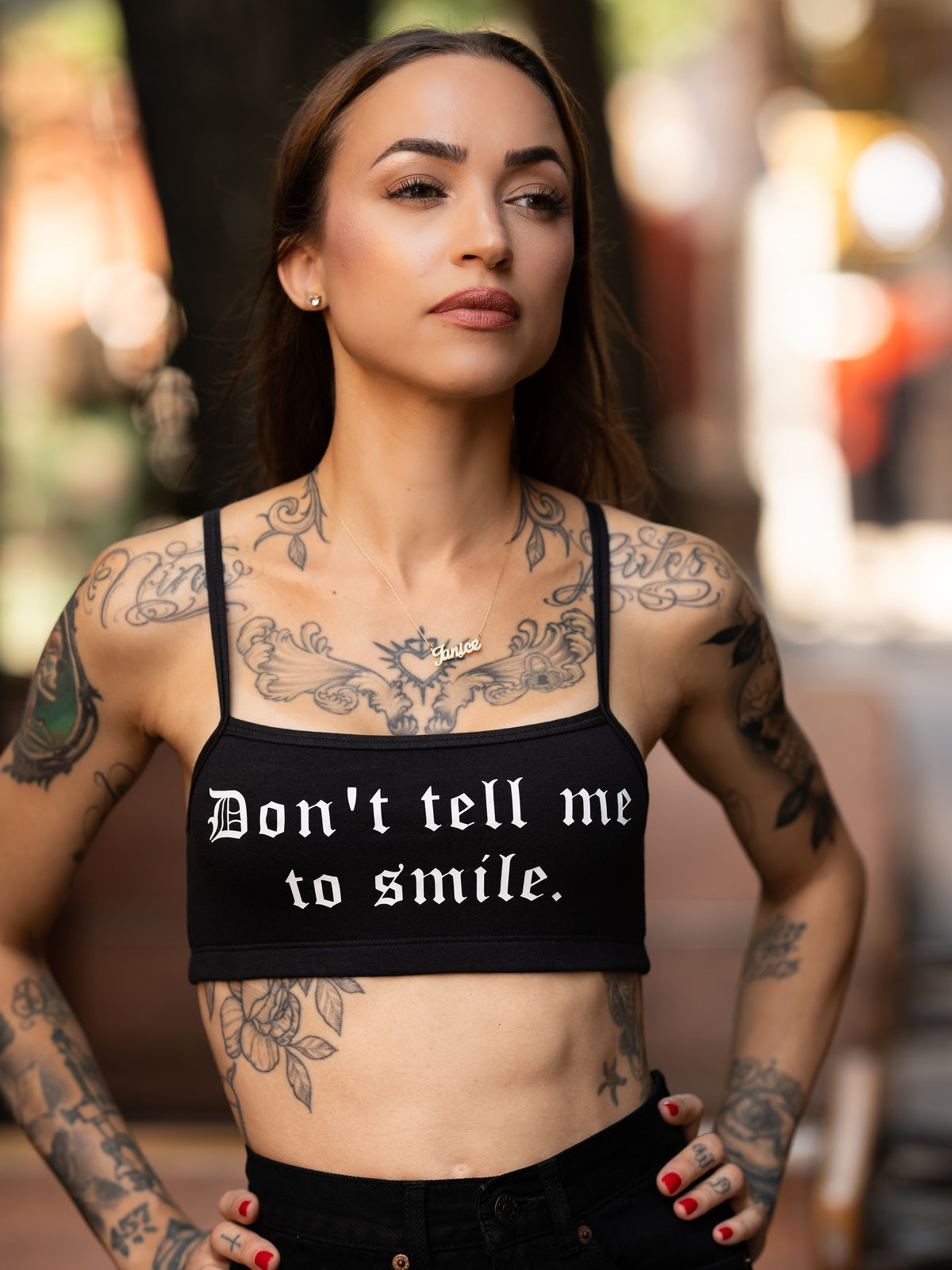 Janice Danger wearing a "Dont Tell Me To Smile" black bralette 