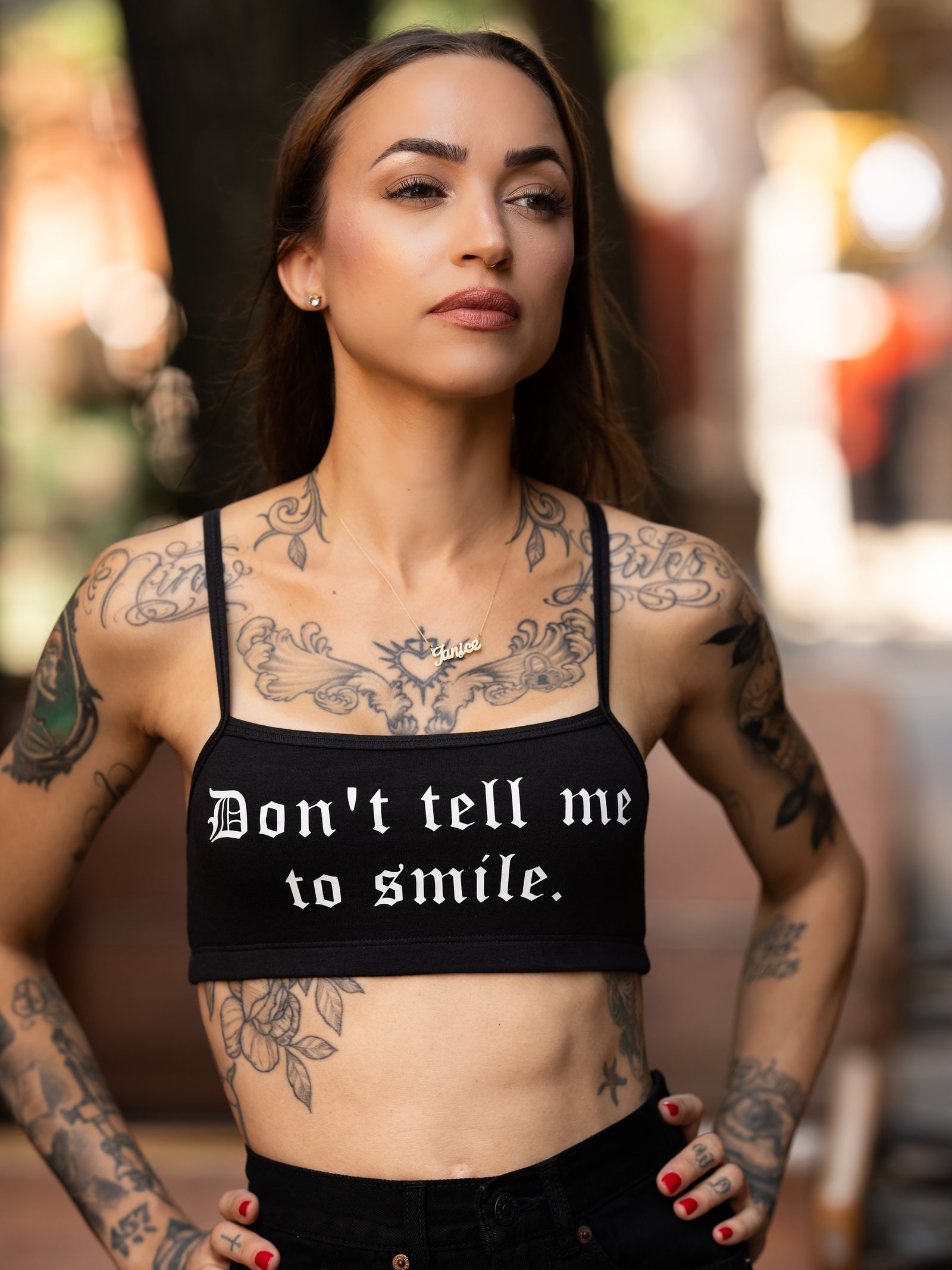 Janice Danger wearing a "Dont Tell Me To Smile" black bralette 