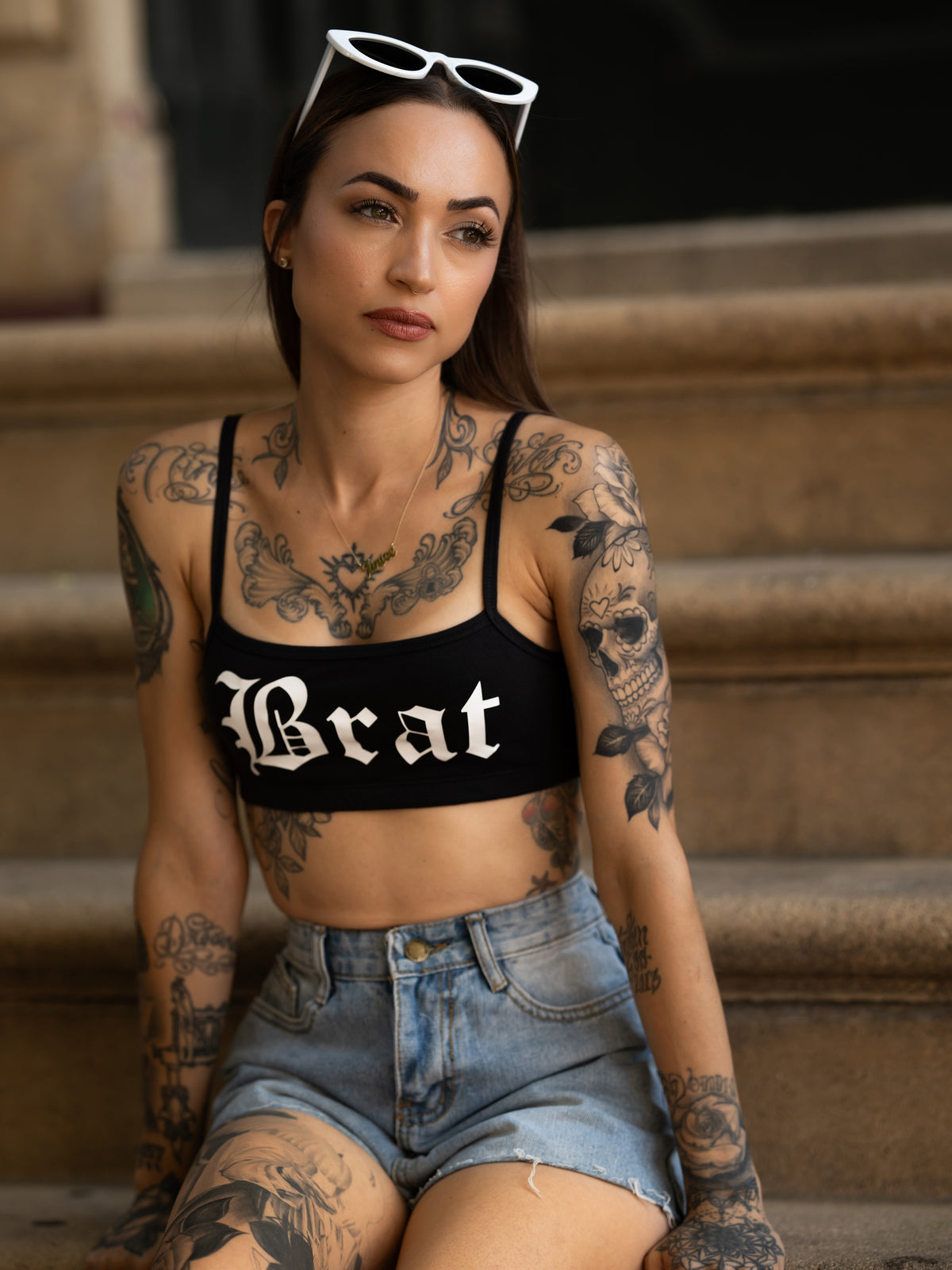 Janice Danger wearing the Brat black bralette with blue denim shorts