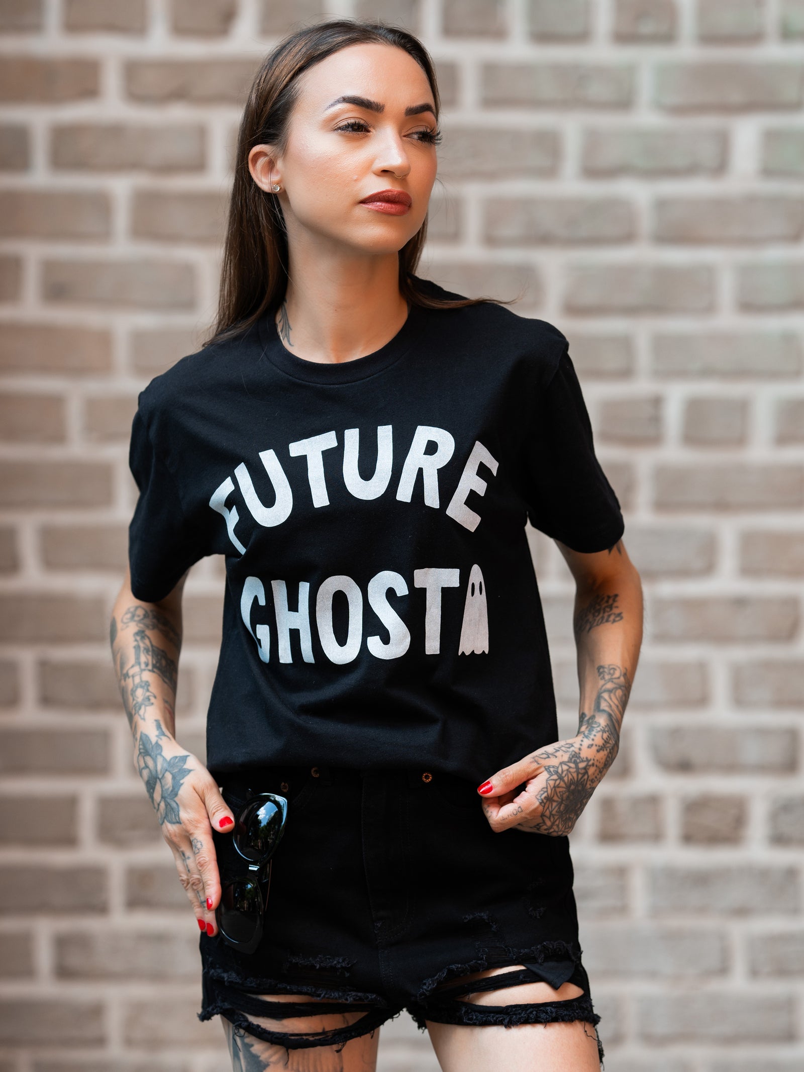 Janice Danger wearing a black, unisex t-shirt with a bold white graphic which reads "future ghost" 