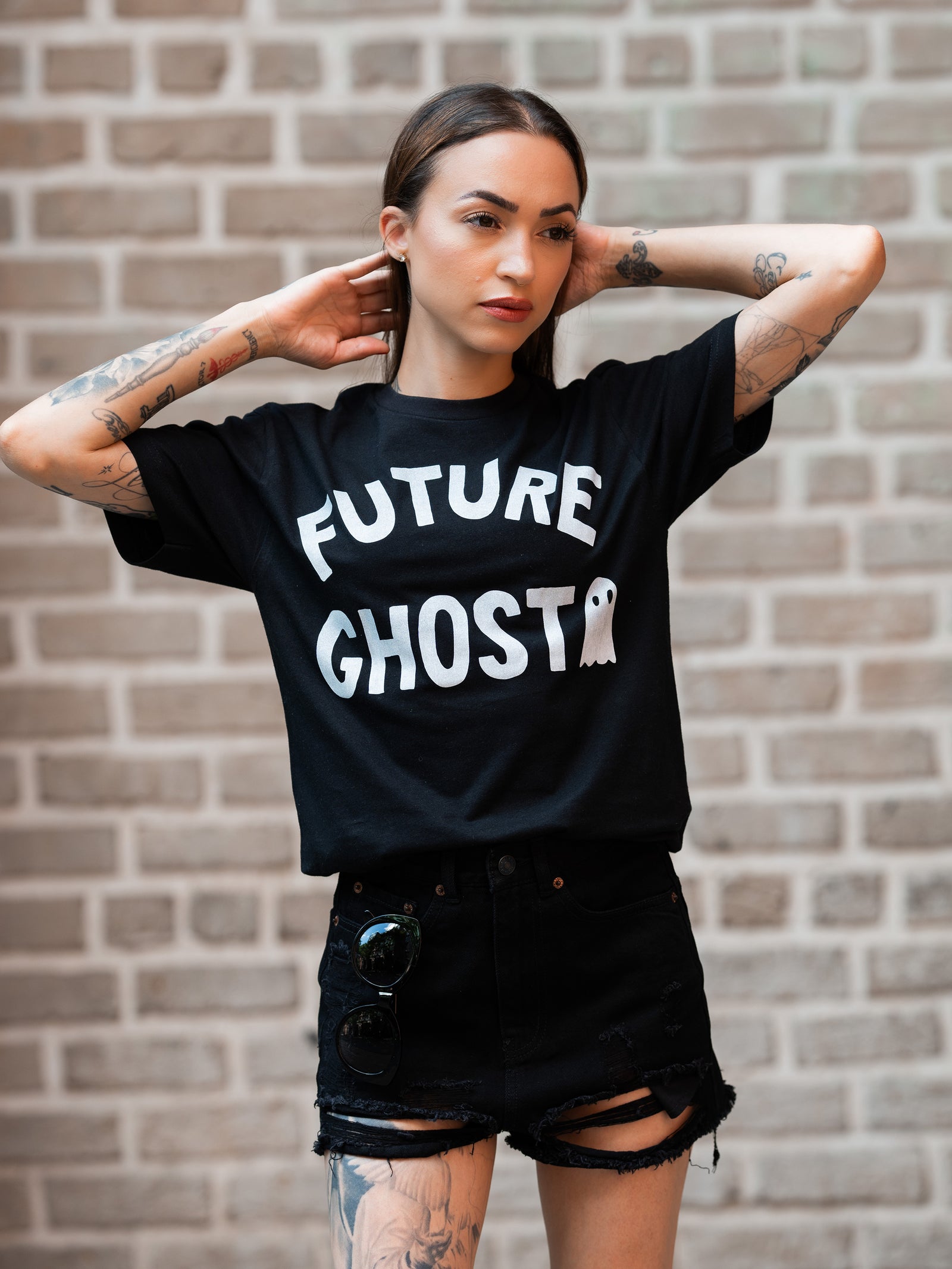 Janice Danger wearing a black, unisex t-shirt with a bold white graphic which reads "future ghost" 