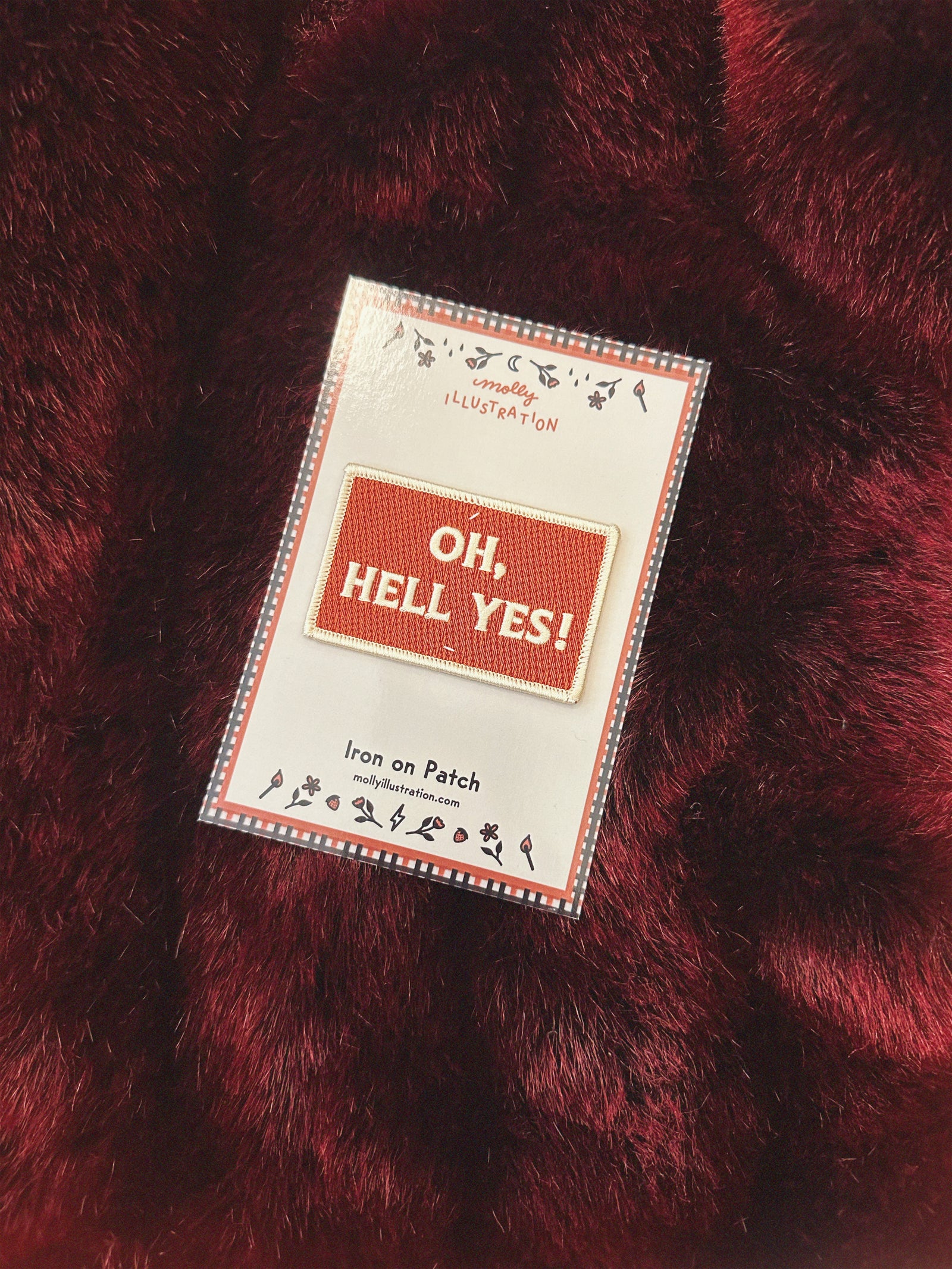 Patch with 'Oh, Hell Yes!' text on a red fabric background