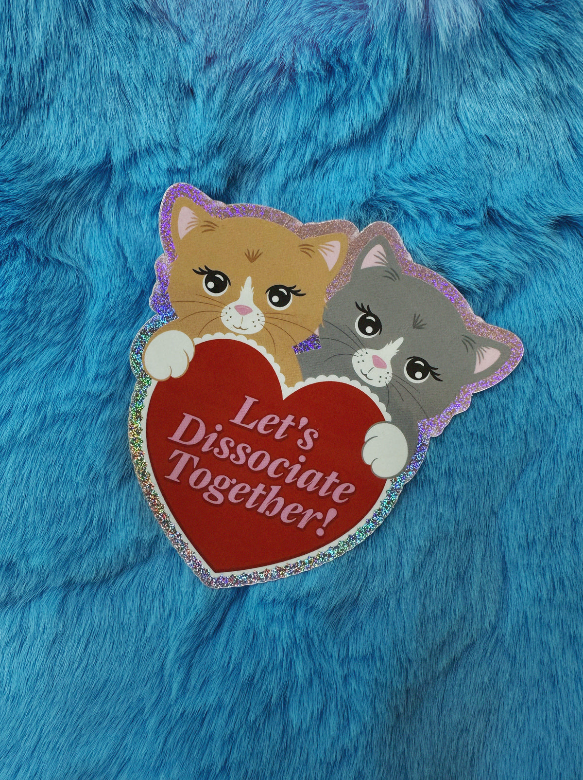 Two cartoon cats holding a heart with text &#39;Let&#39;s Dissociate Together!&#39; on a blue furry background