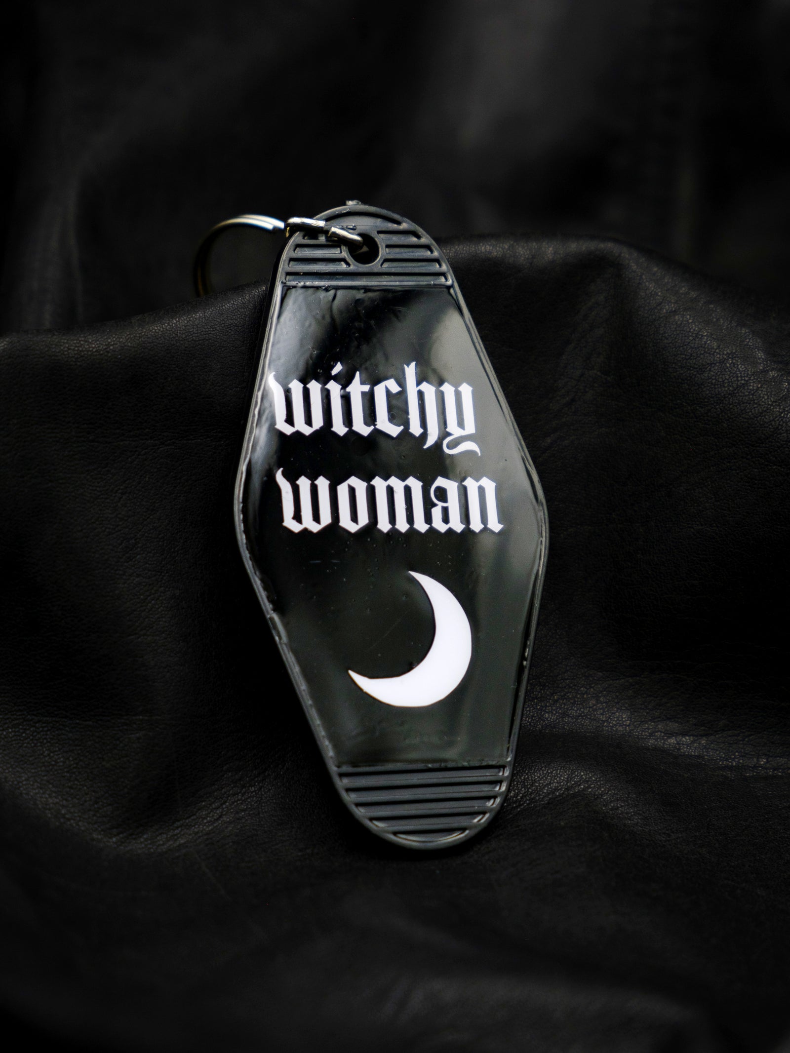 black motel style keychain with crescent moon reads witchy woman in white