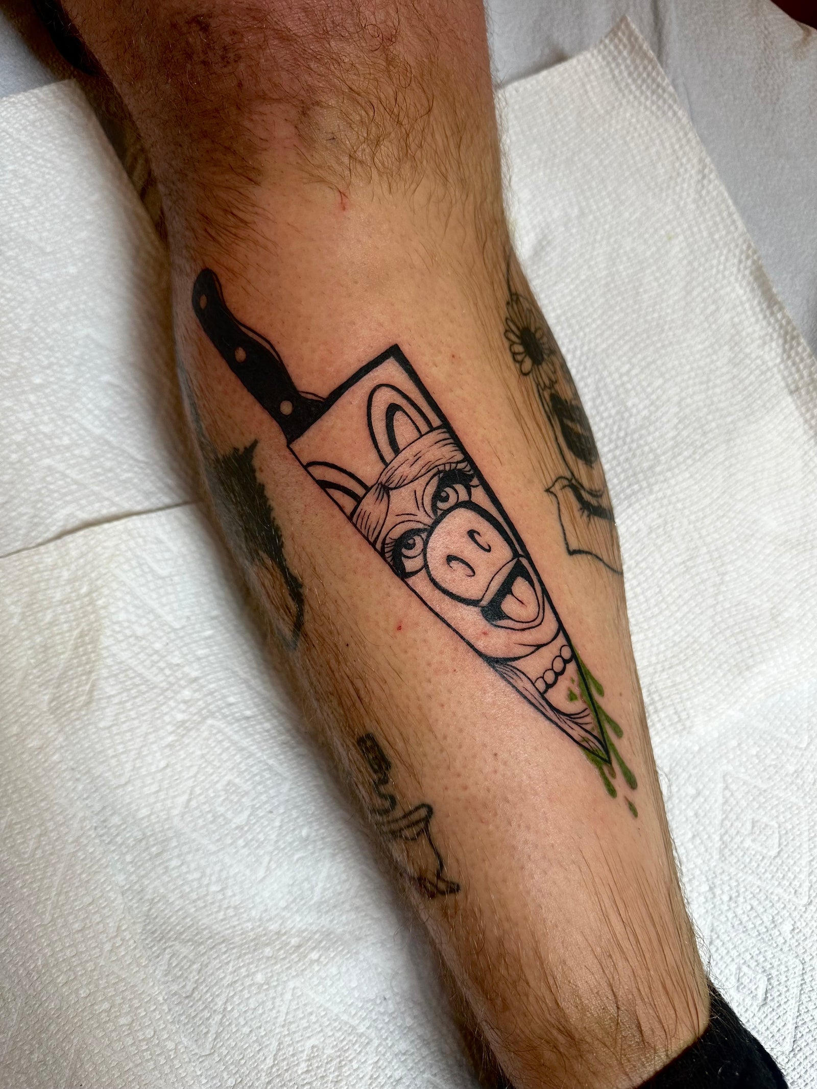Blackwork Miss Piggy chef's knife lower leg tattoo by Miss Vampira