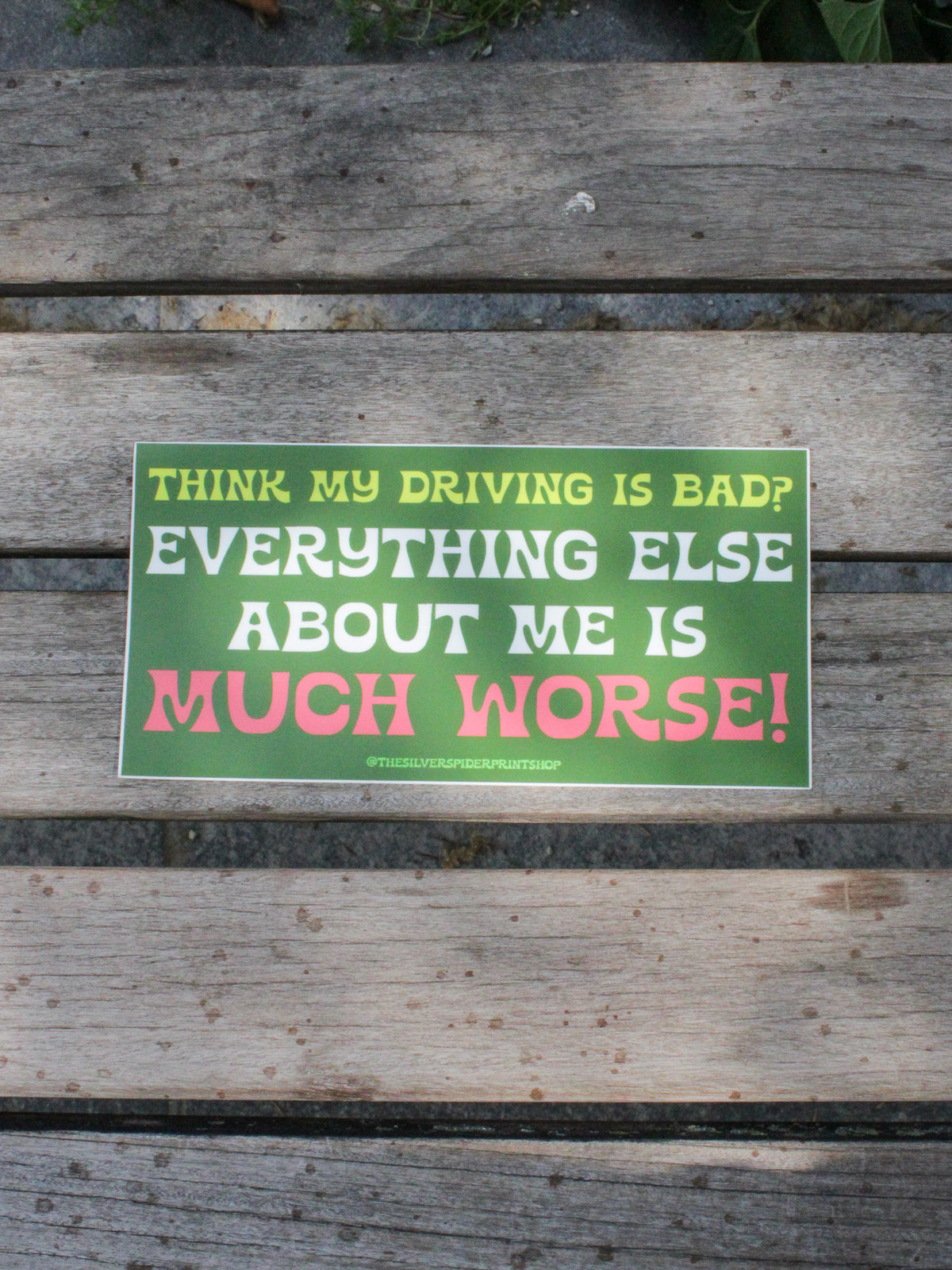 green oversize bumper sticker reads &quot;Think My Driving is Bad? Everything Else About Me is Much Worse!&quot; in lime green, white, and pink
