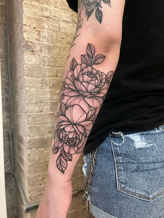 Black and gray floral forearm tattoo by Janice Danger