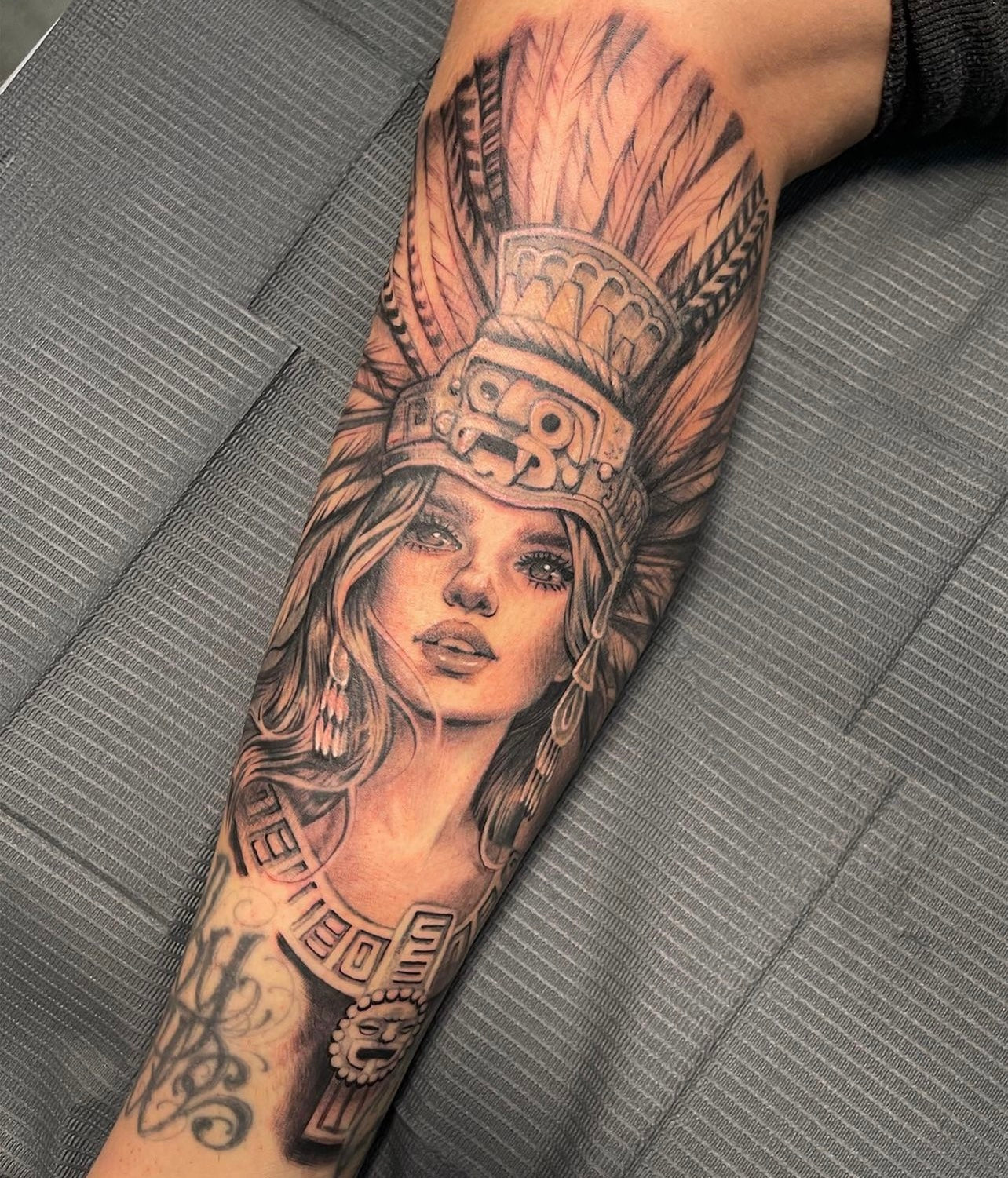 Black and gray lower leg tattoo by Elvia Guadian