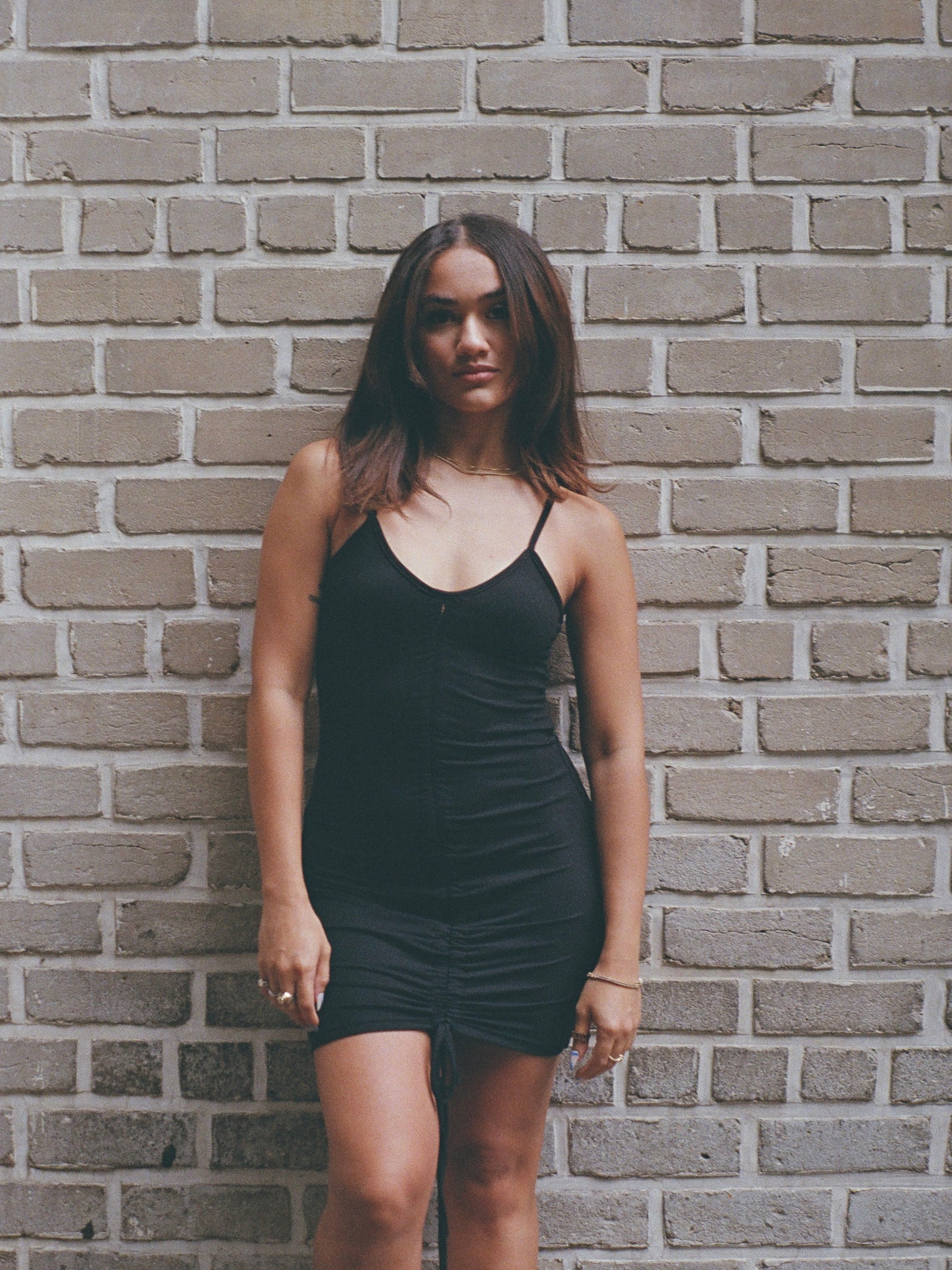 Model wearing a cami strapped, soft mini dress.