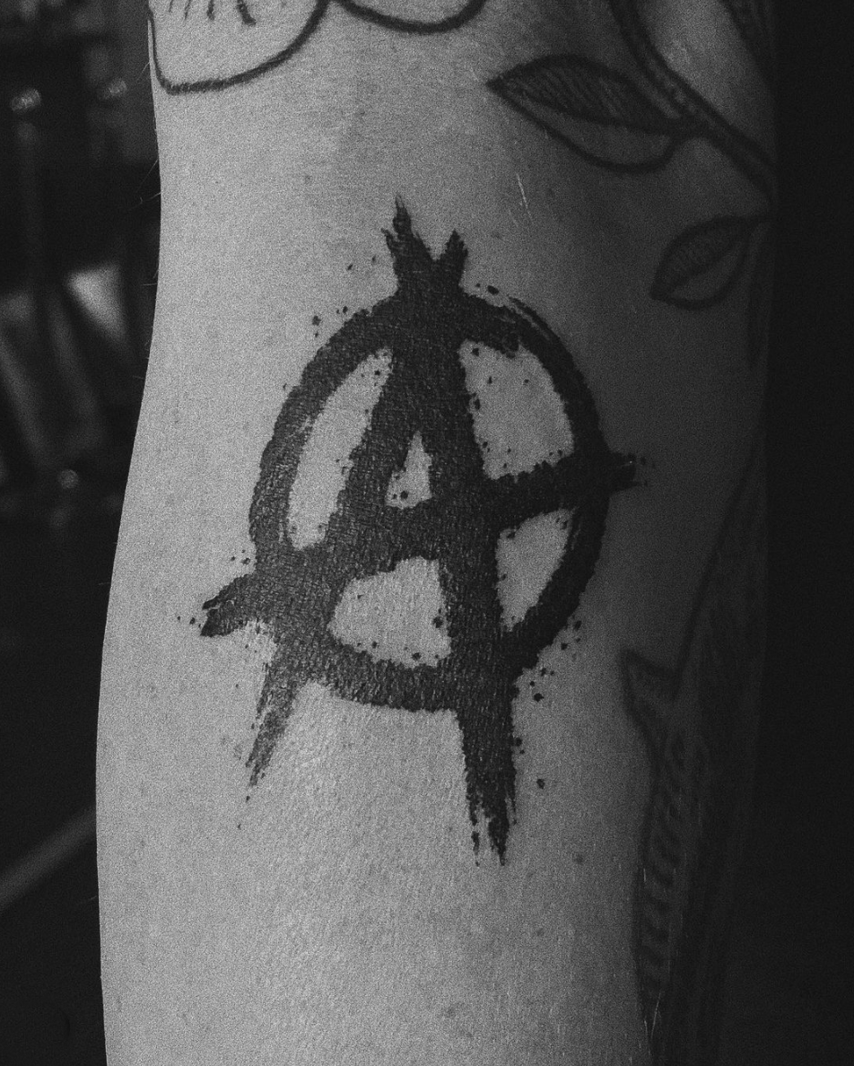 gritty Anarchy sign blackwork tattoo by Cavan Infante typography logo 