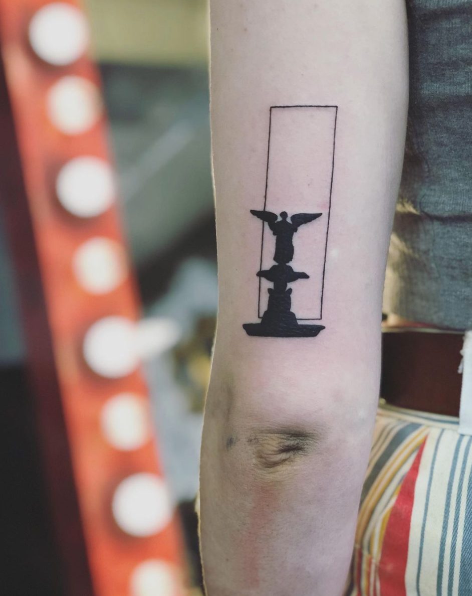 minimal, high contrast blackwork statue tattoo geometric by Cavan Infante upper arm above elbow