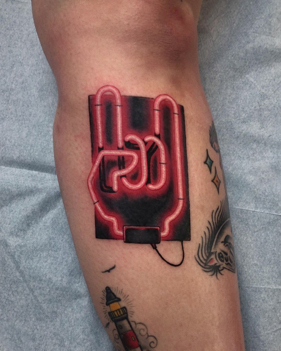 Rock hand red neon sign leg tattoo by Cavan Infante