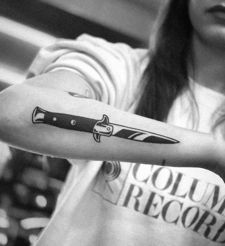 bold black work stiletto knife forearm tattoo by Cavan Infante