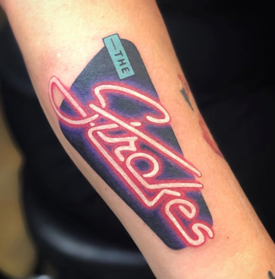 pink neon sign Strokes color arm tattoo by Cavan Infante