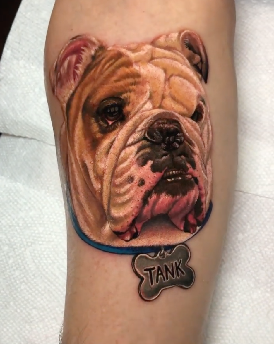 Photorealistic dog portrait tattoo by Megan Massacre