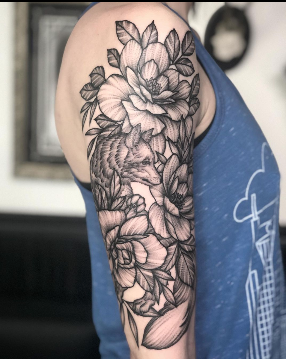 blackwork fox and floral arm tattoo with stipple shading by Janice Danger