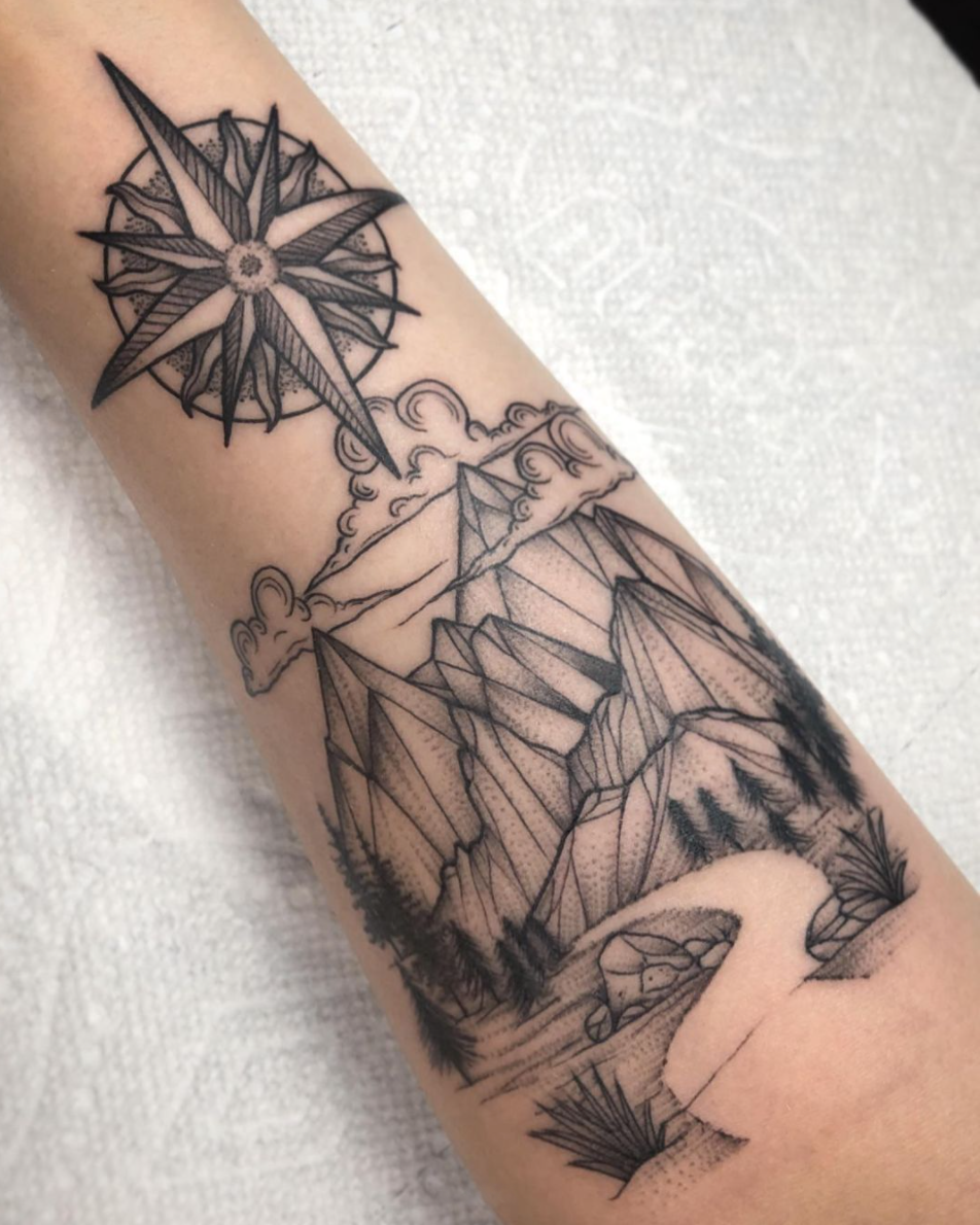 Mountain and compass rose black and grey blackwork nature scene tattoo by Janice Danger