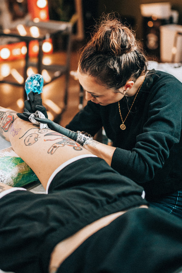 Janice Danger tattooing a knee at Grit N Glory, FAQ link