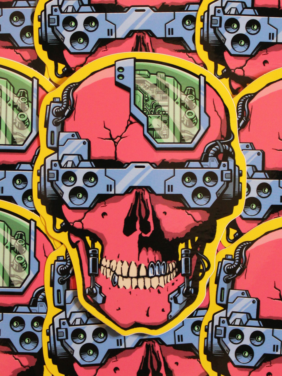 A colorful vinyl sticker depicting a skull with cyber punk aesthetics, including blue and yellow electronic components over a pink and red background.