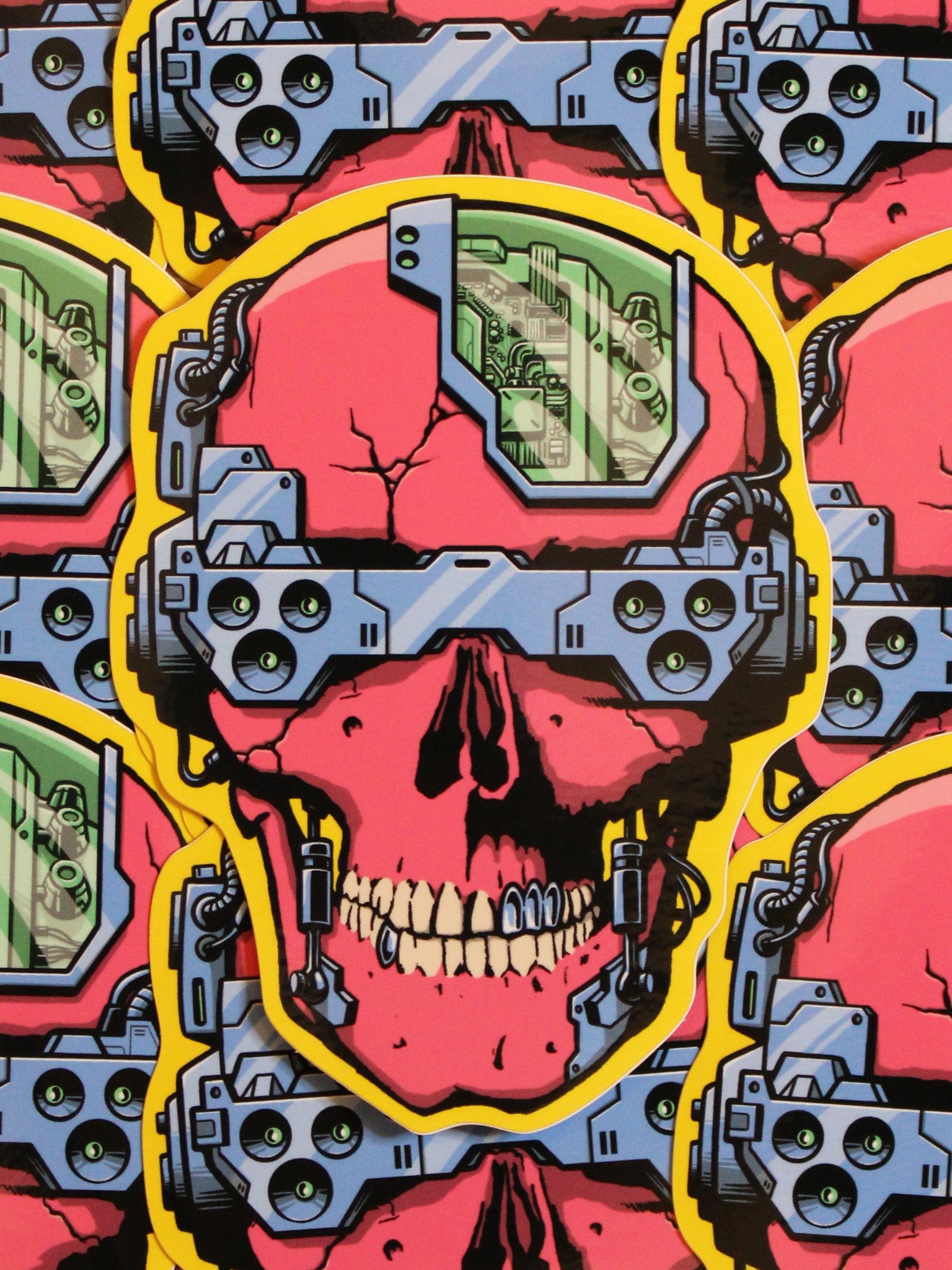 A colorful vinyl sticker depicting a skull with cyber punk aesthetics, including blue and yellow electronic components over a pink and red background.