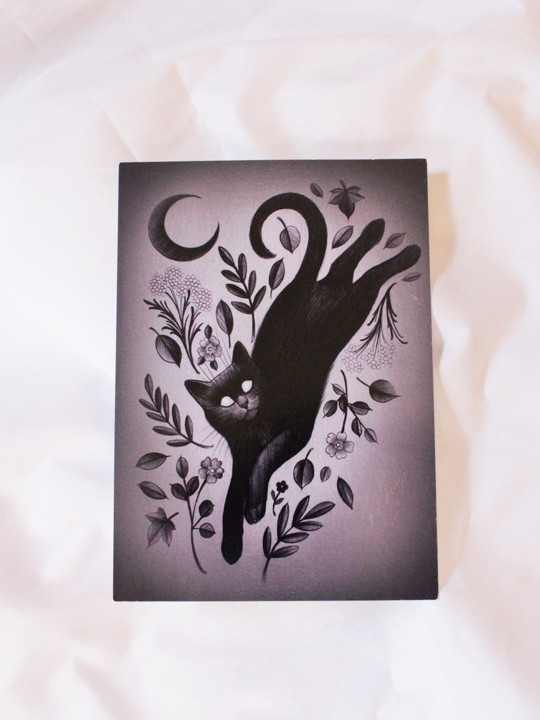 Charlotte Timmons' Ghost Cat print featuring a leaping black cat with a crescent moon, foliage, and florals.