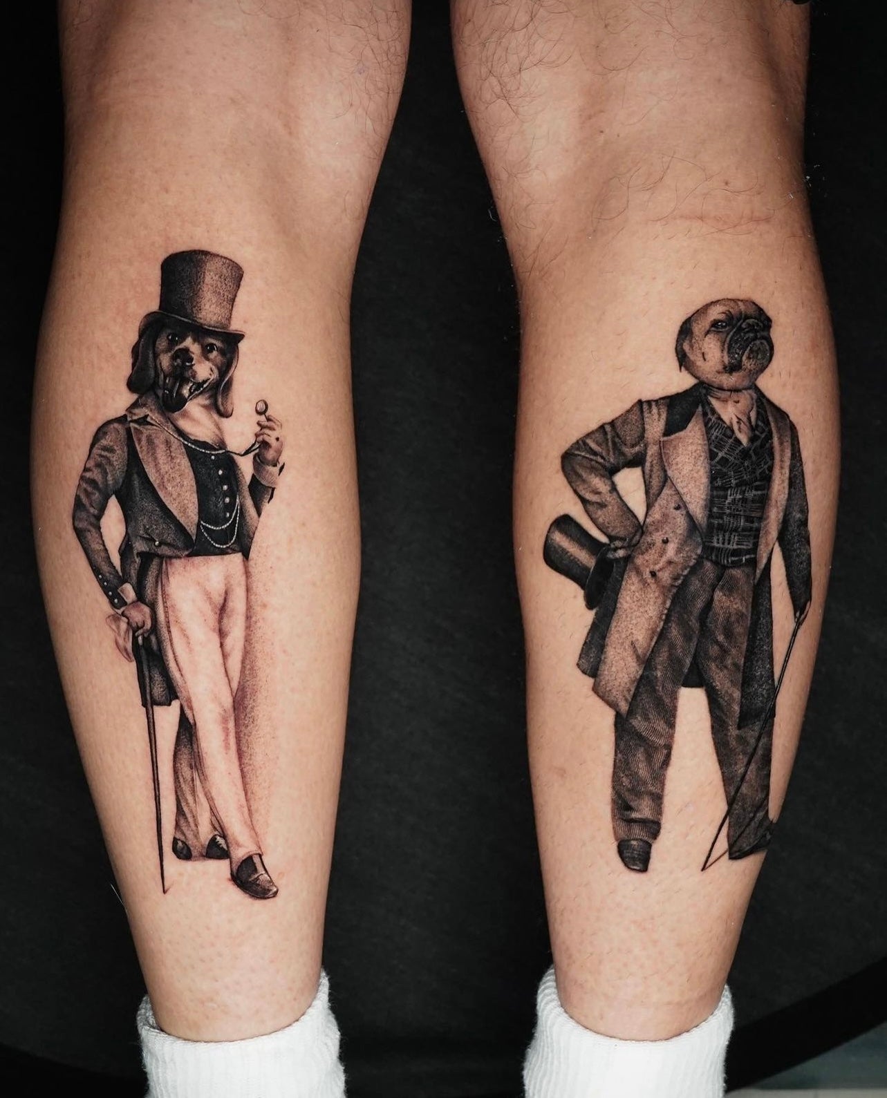 Black and gray dapper pet portrait tattoos. These calf tattoos feature a beagle and pug dg in dapper outfits made by Joanna Gacek