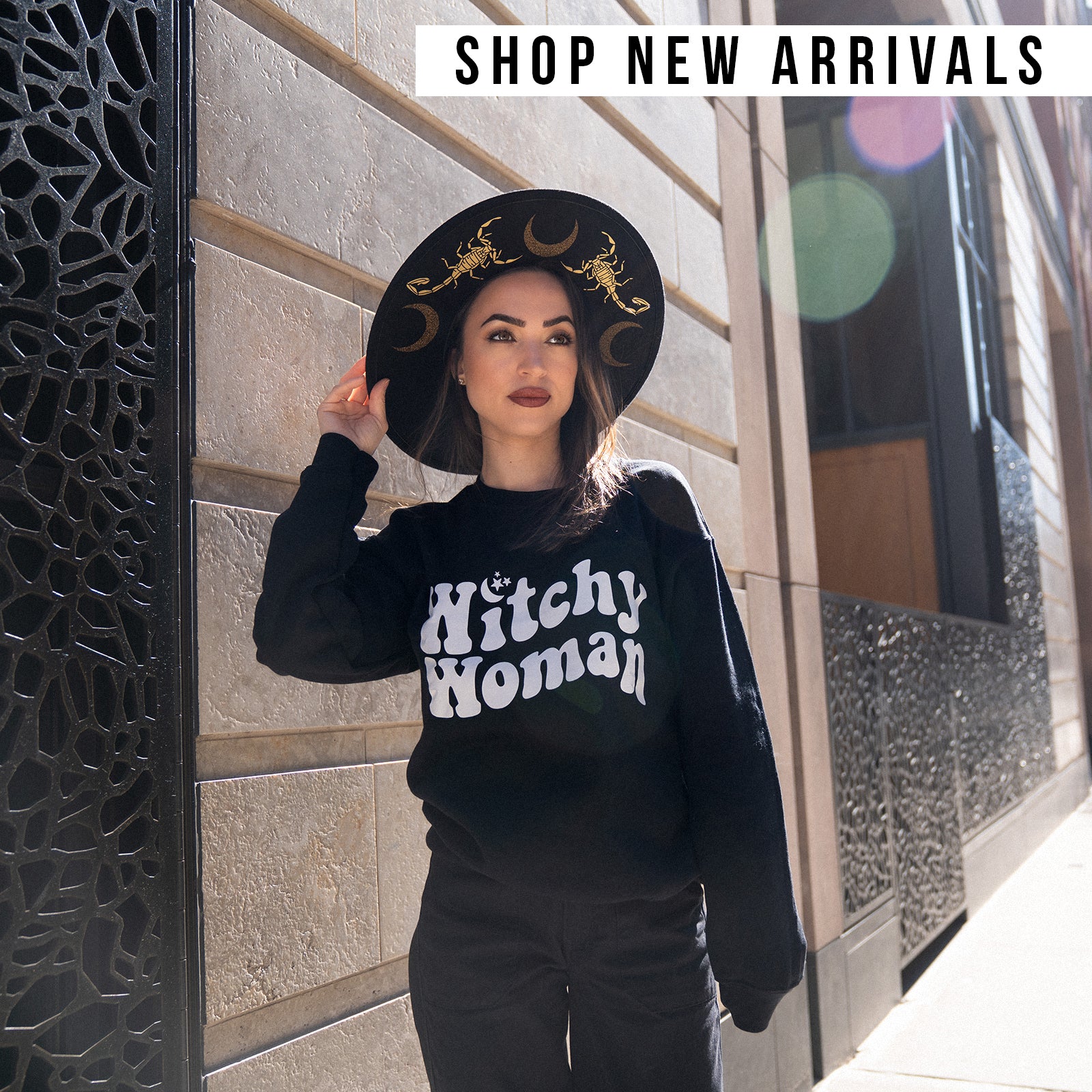 New Arrivals Square Graphic featuring Janice Danger in the Scorpions and Moons Felt Hat and Witchy Woman black and white crewneck sweatshirt. Photographed outdoors in Greenwich Village NYC