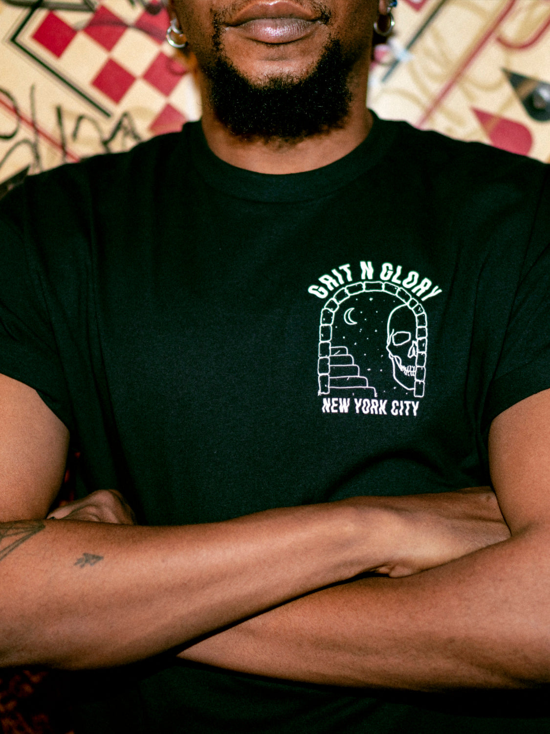 Detail of the If Lost Graphic featuring a portal with skull, crescent moon, and stairs. Text reads Grit N Glory New York City