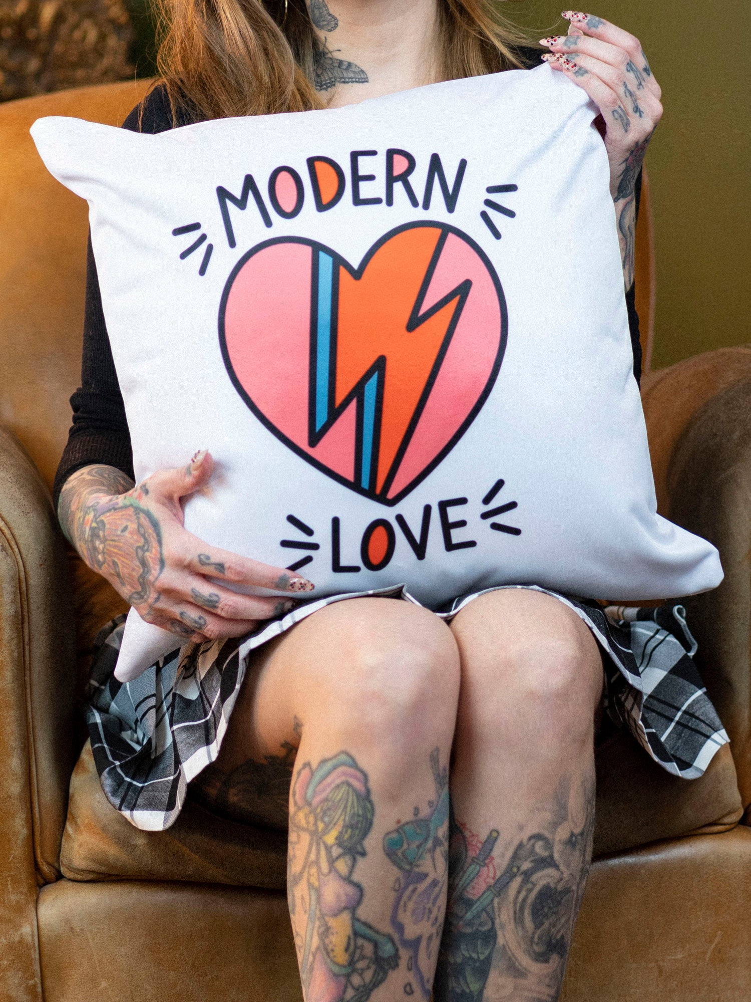 Megan Massacre with white throw pillow with Modern Love David Bowie inspired graphic design.