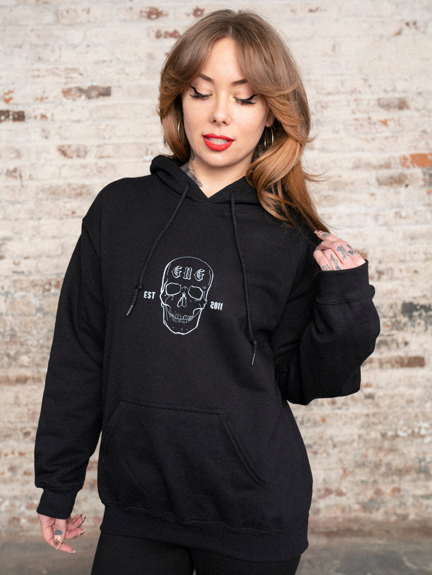 Megan Massacre wearing a black hoodie with GNG skull in the front.