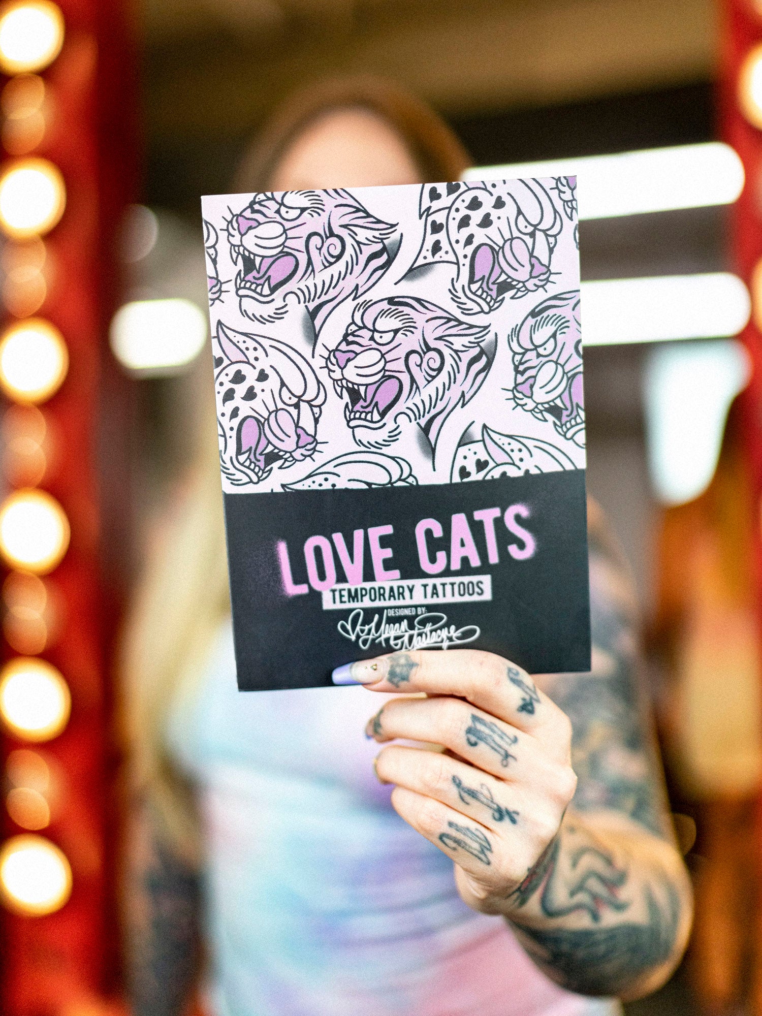 Love Cat temporary tattoo packaging held by Megan Massacre