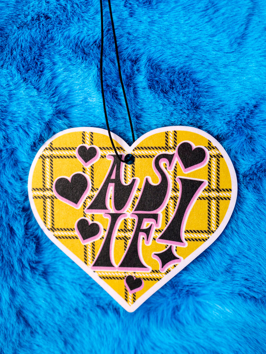 Clueless inspired 90's, heart shaped yellow plaid air freshener on a furry blue background.