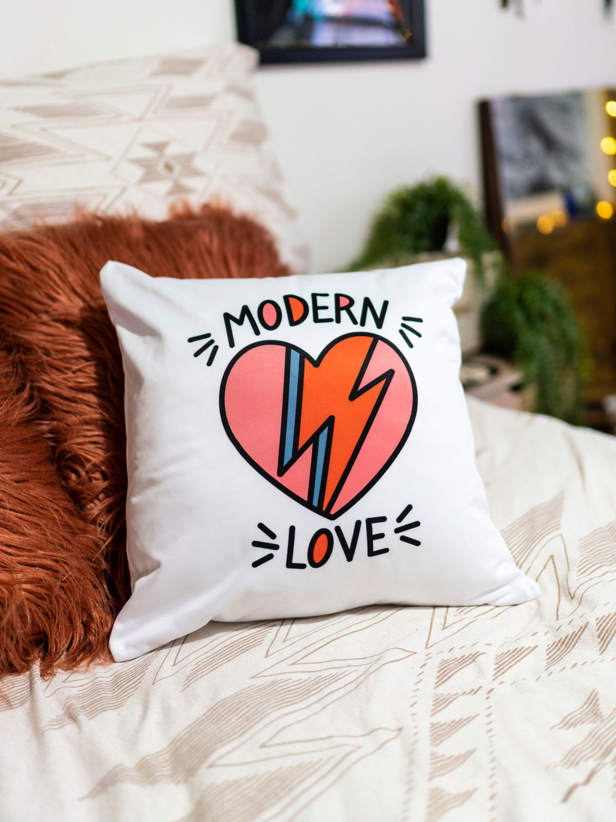 White throw pillow with Modern Love David Bowie inspired graphic design.