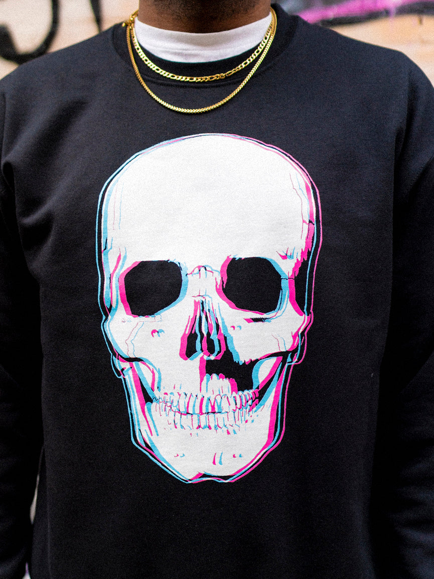A person wearing a black crewneck sweatshirt with a 3D style skull graphic on the front.