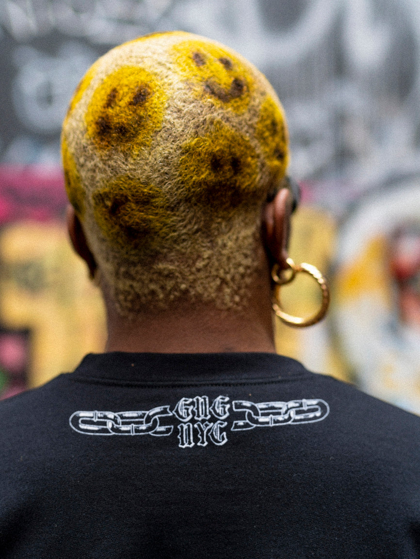 Back detail of a broken chain grahpic with text that reads "GNG NYC" just below the neck line on the 3d crewneck. 
